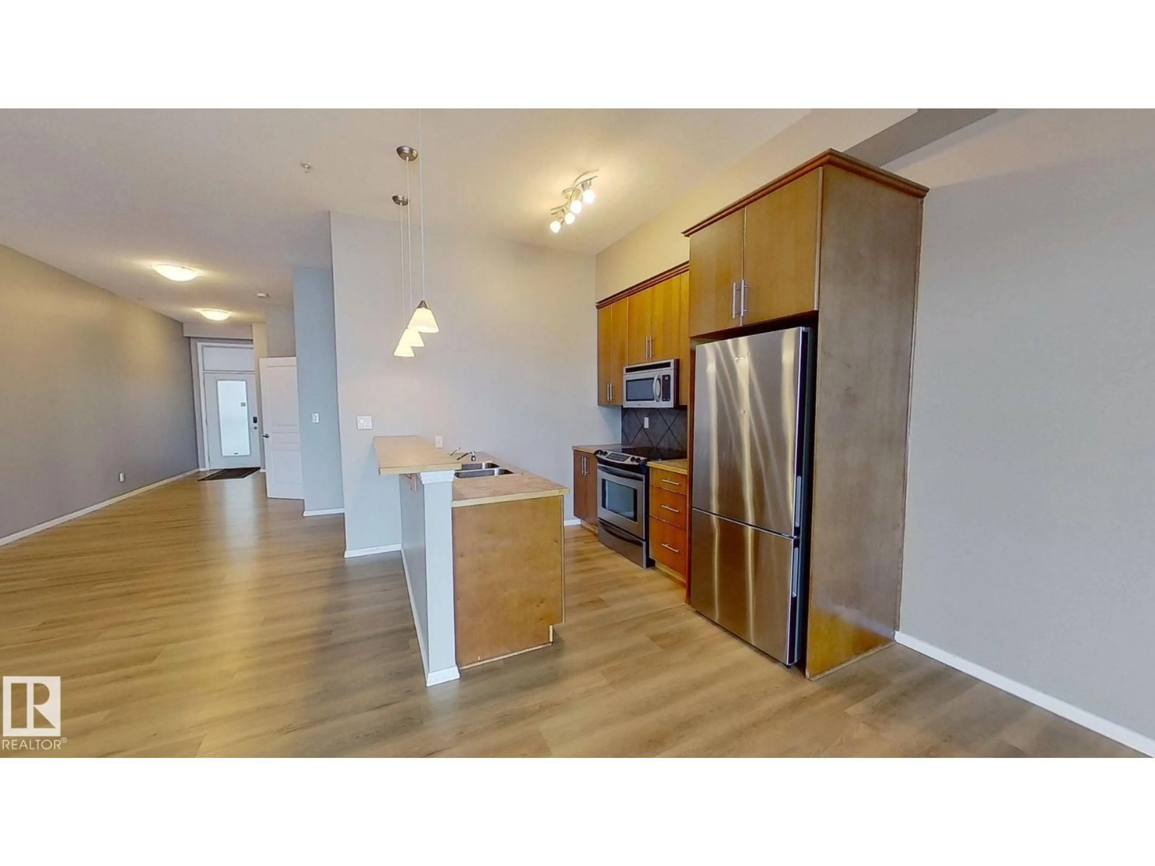 Open concept kitchen, wood/laminate floor for #215 - 10531 117 ST, Edmonton Alberta T5H0A8
