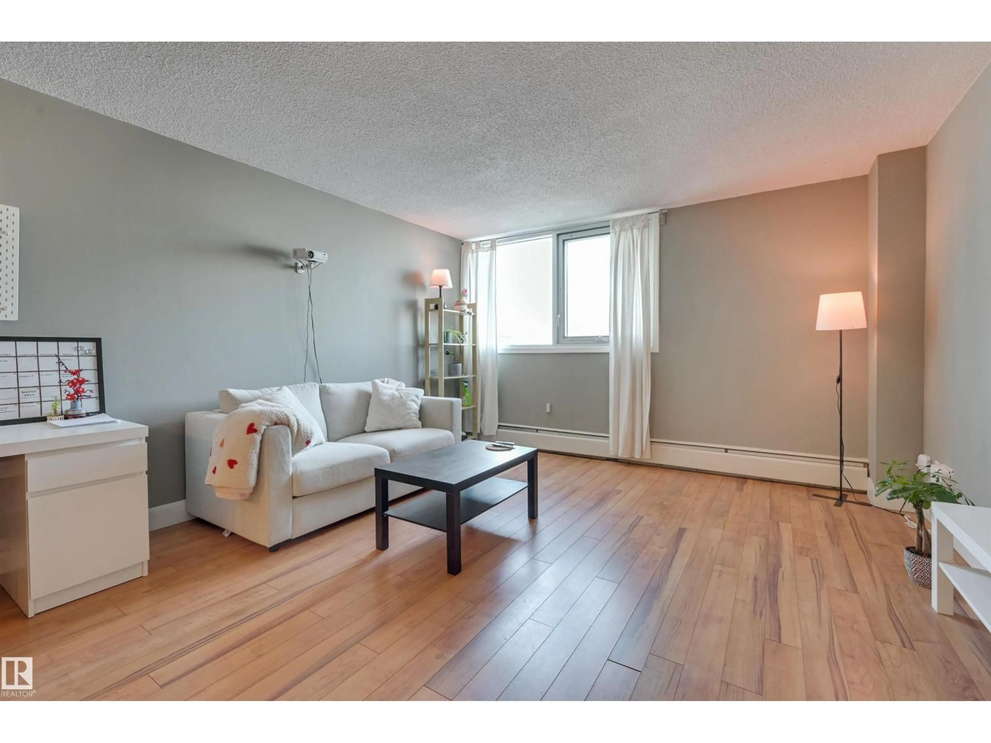 Living room with furniture, wood/laminate floor for 10011 - 1001 116 ST, Edmonton Alberta T5K1V4