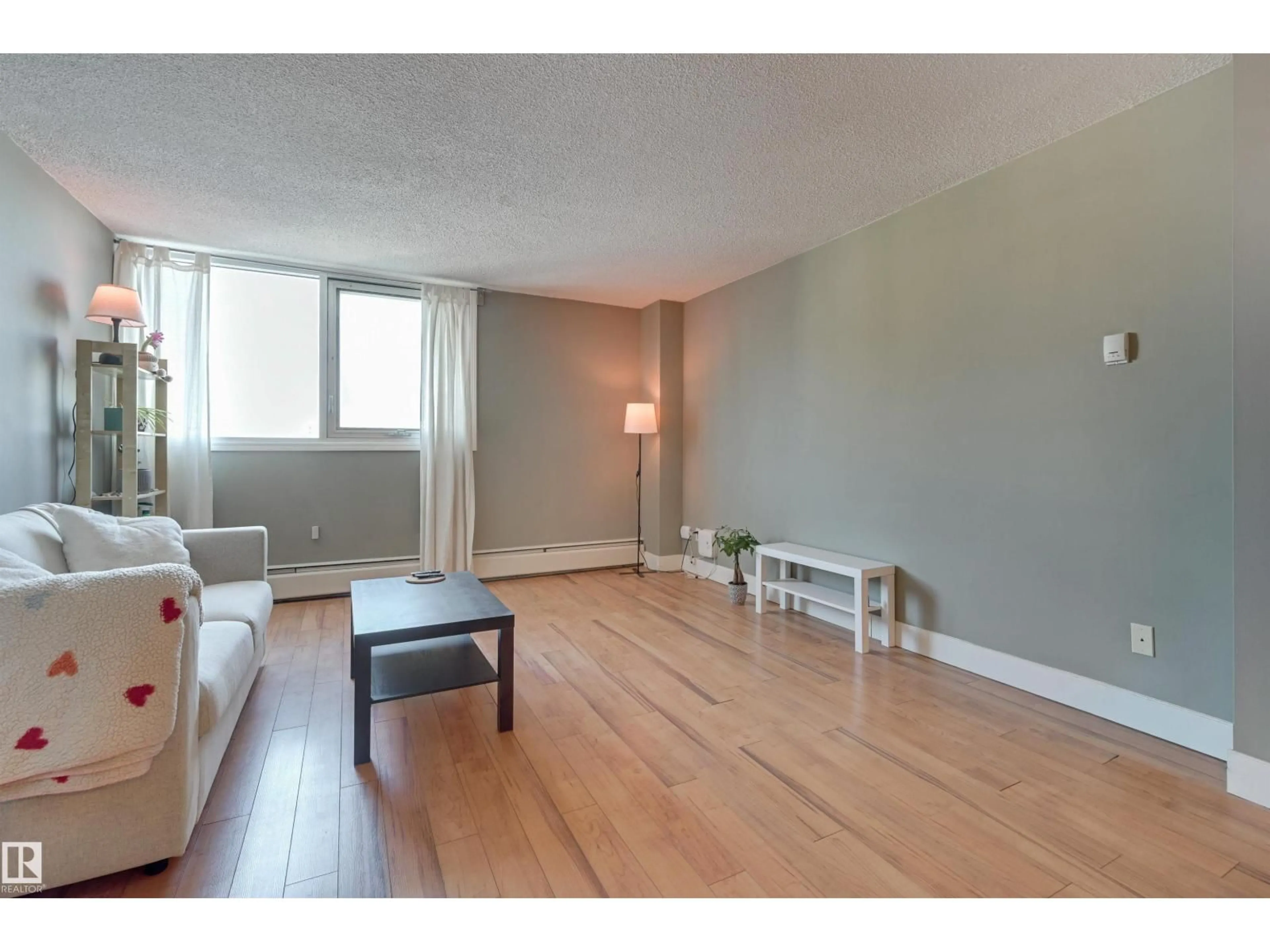 Living room with furniture, wood/laminate floor for 10011 - 1001 116 ST, Edmonton Alberta T5K1V4