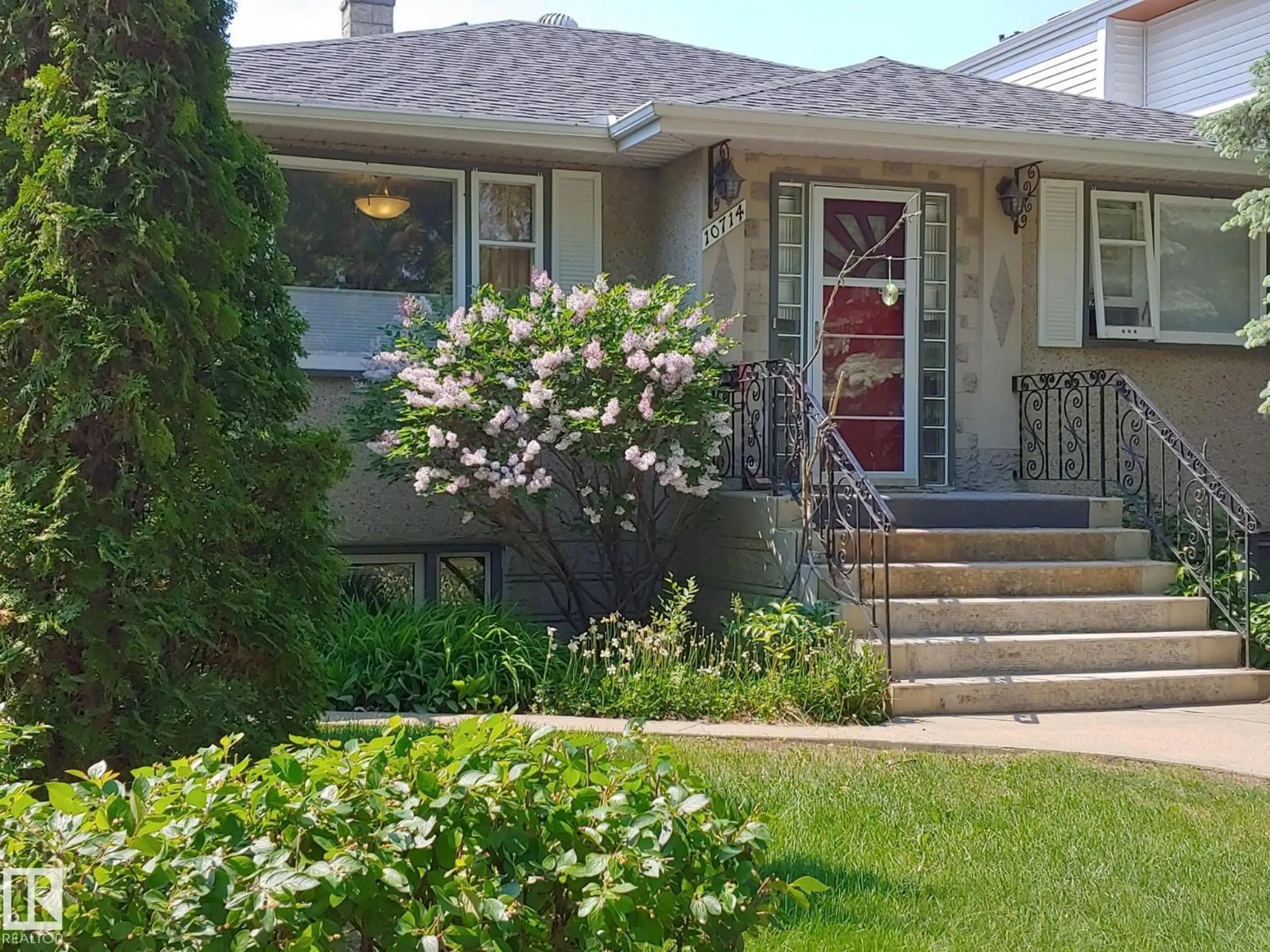 Home with vinyl exterior material, street for NW - 10714 128 ST, Edmonton Alberta T5M0V9