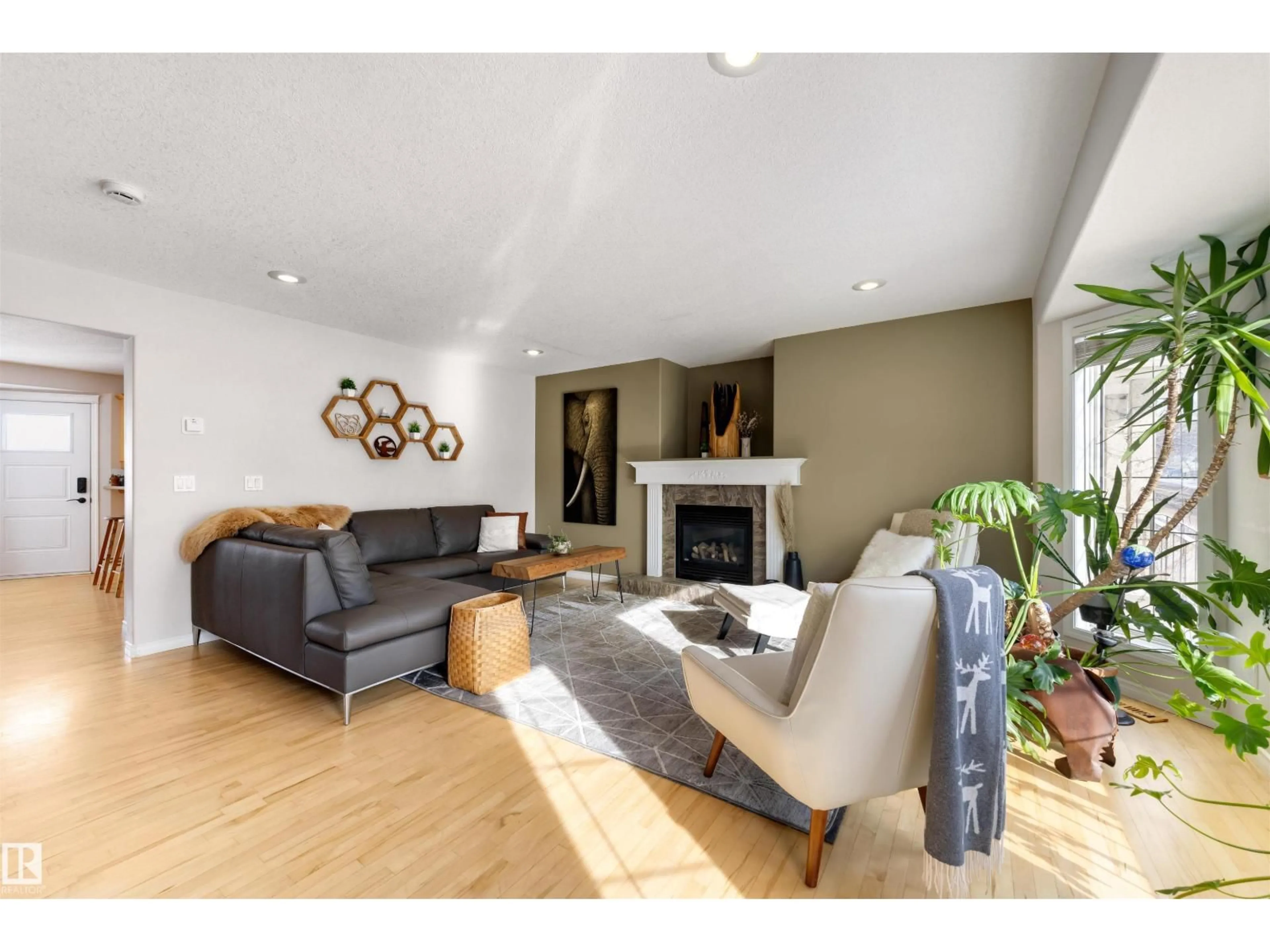 Living room with furniture, wood/laminate floor for 8818 ROWLAND RD, Edmonton Alberta T5H3W4