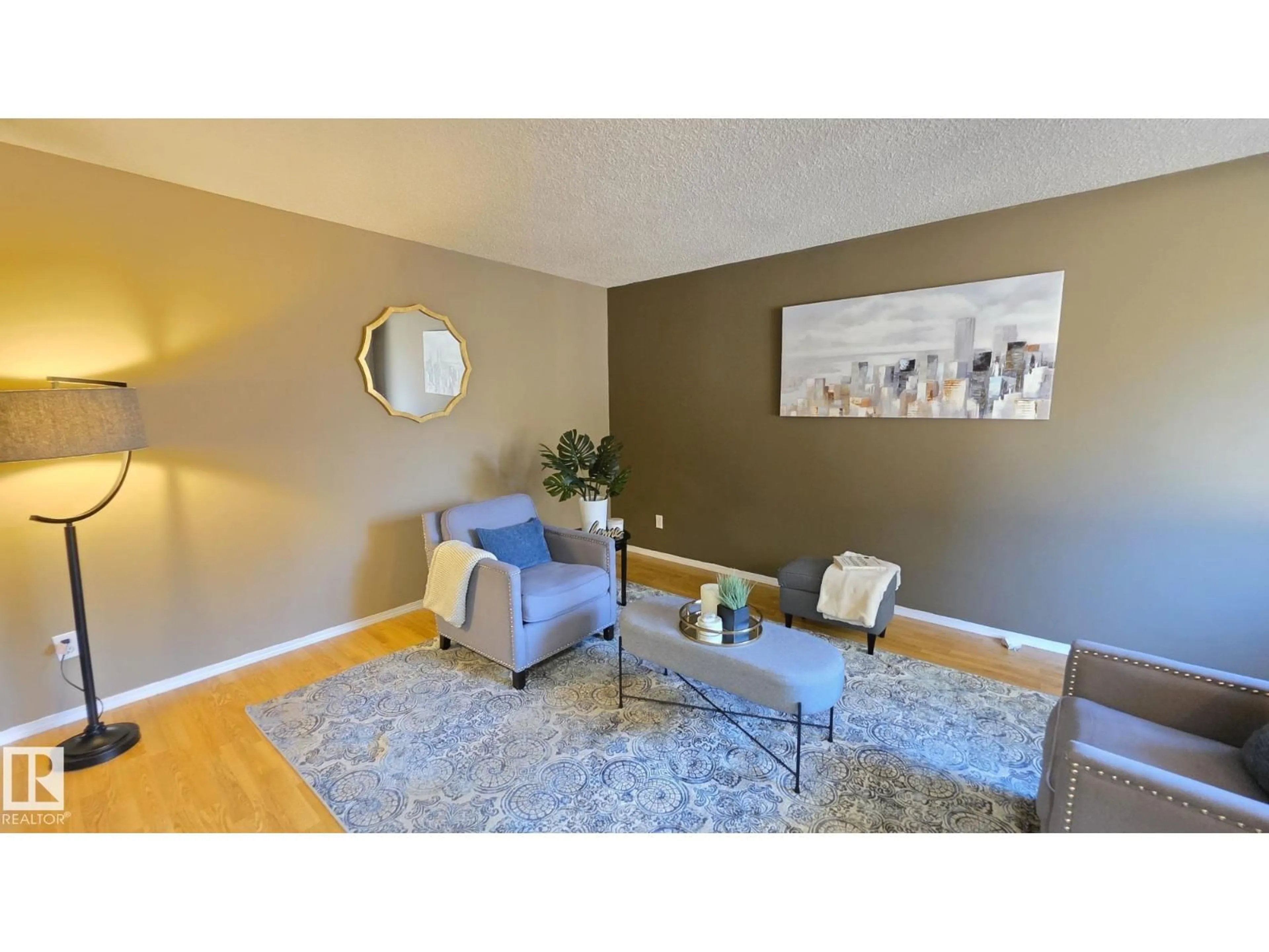 Living room with furniture, wood/laminate floor for 117 LONDONDERRY SQUARE, Edmonton Alberta T5C3C4