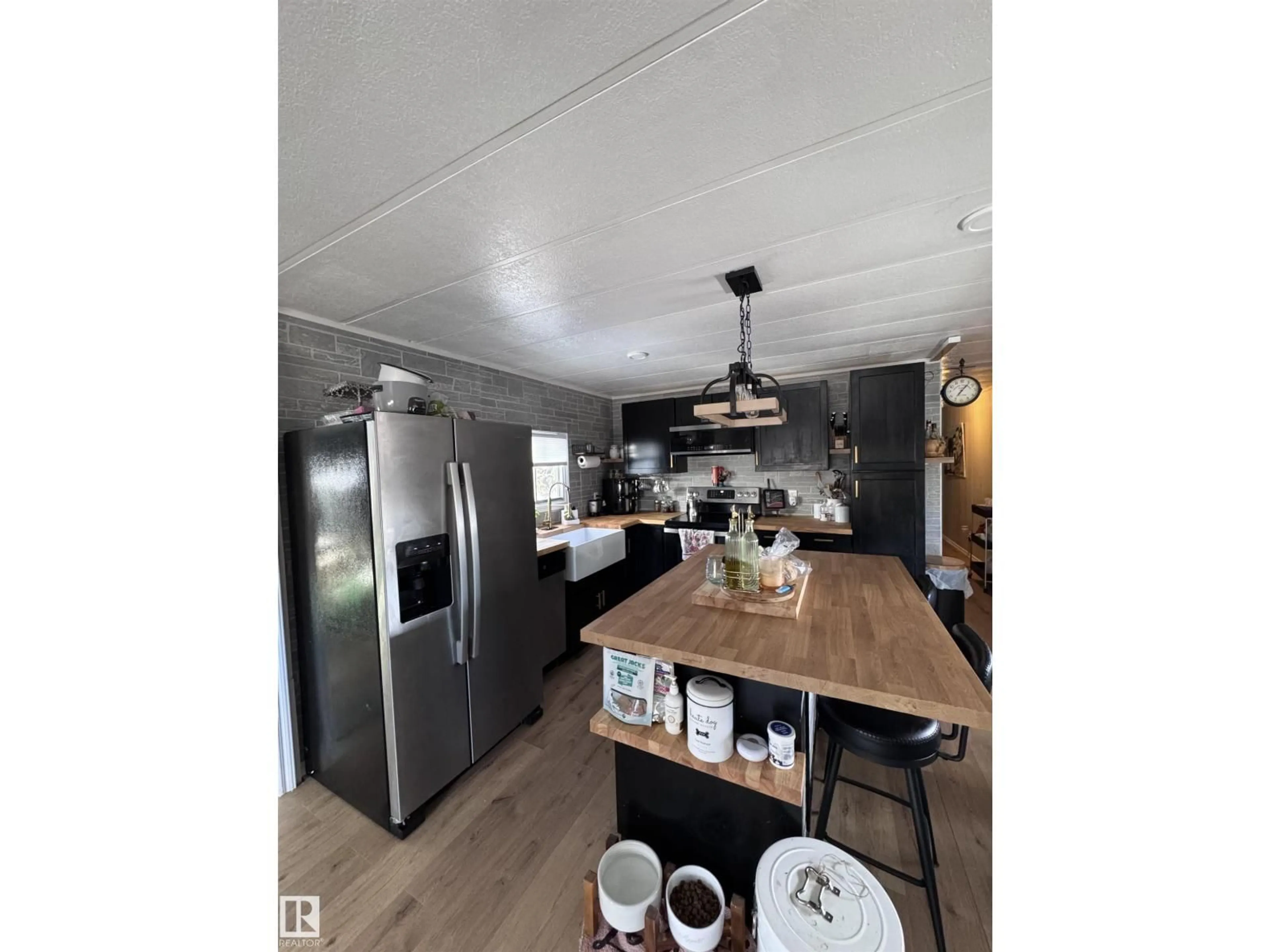 Open concept kitchen, wood/laminate floor for #44 - 9501 104V AVE, Westlock Alberta T7P1M7