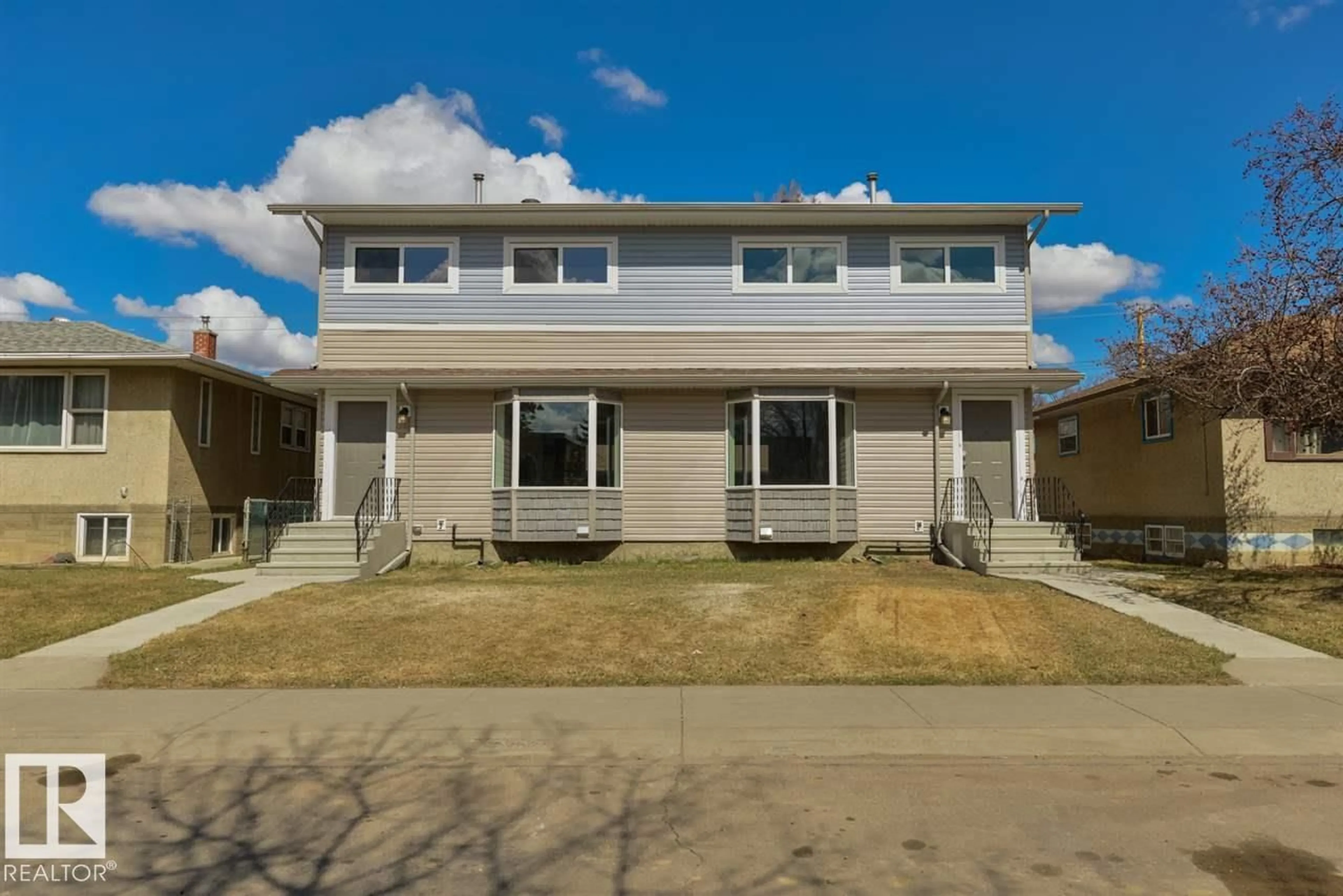 Home with vinyl exterior material, street for NW - 7940/7942 82 AV, Edmonton Alberta T6C0Y2
