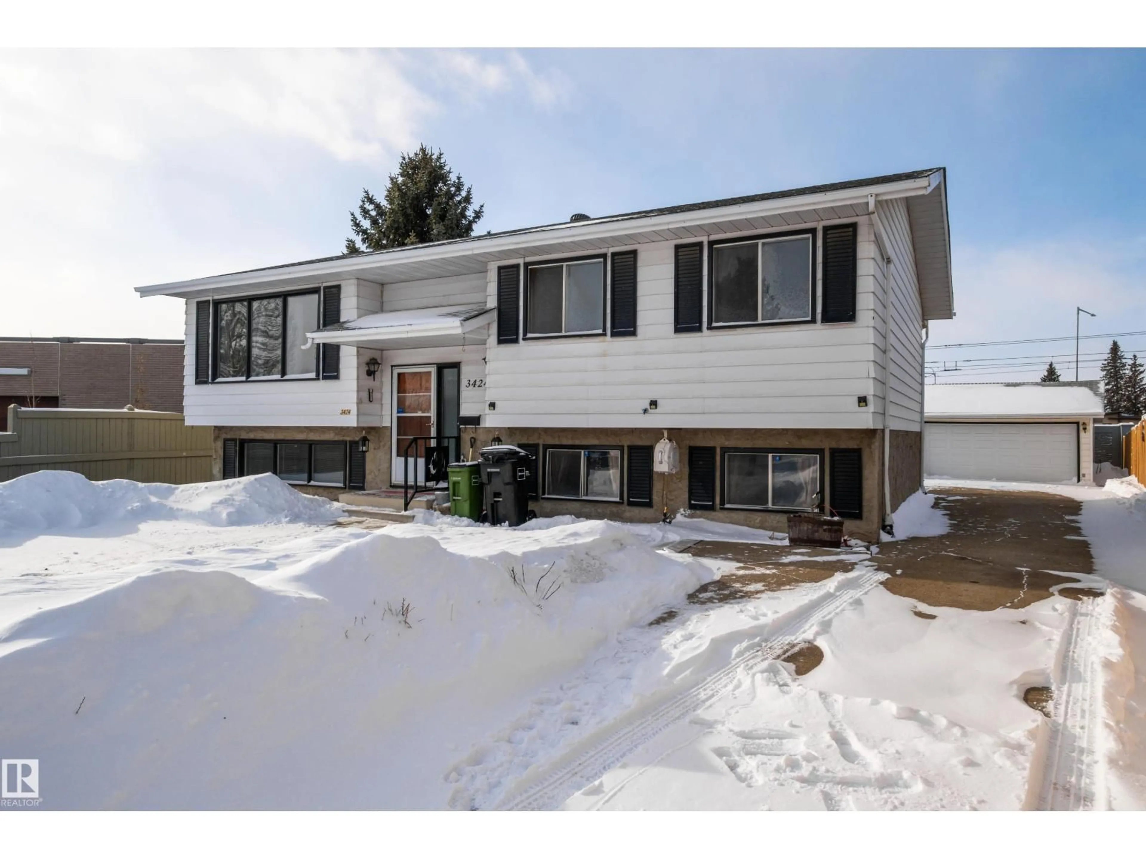 Home with vinyl exterior material, street for NW - 3424 65 ST, Edmonton Alberta T6L2C6