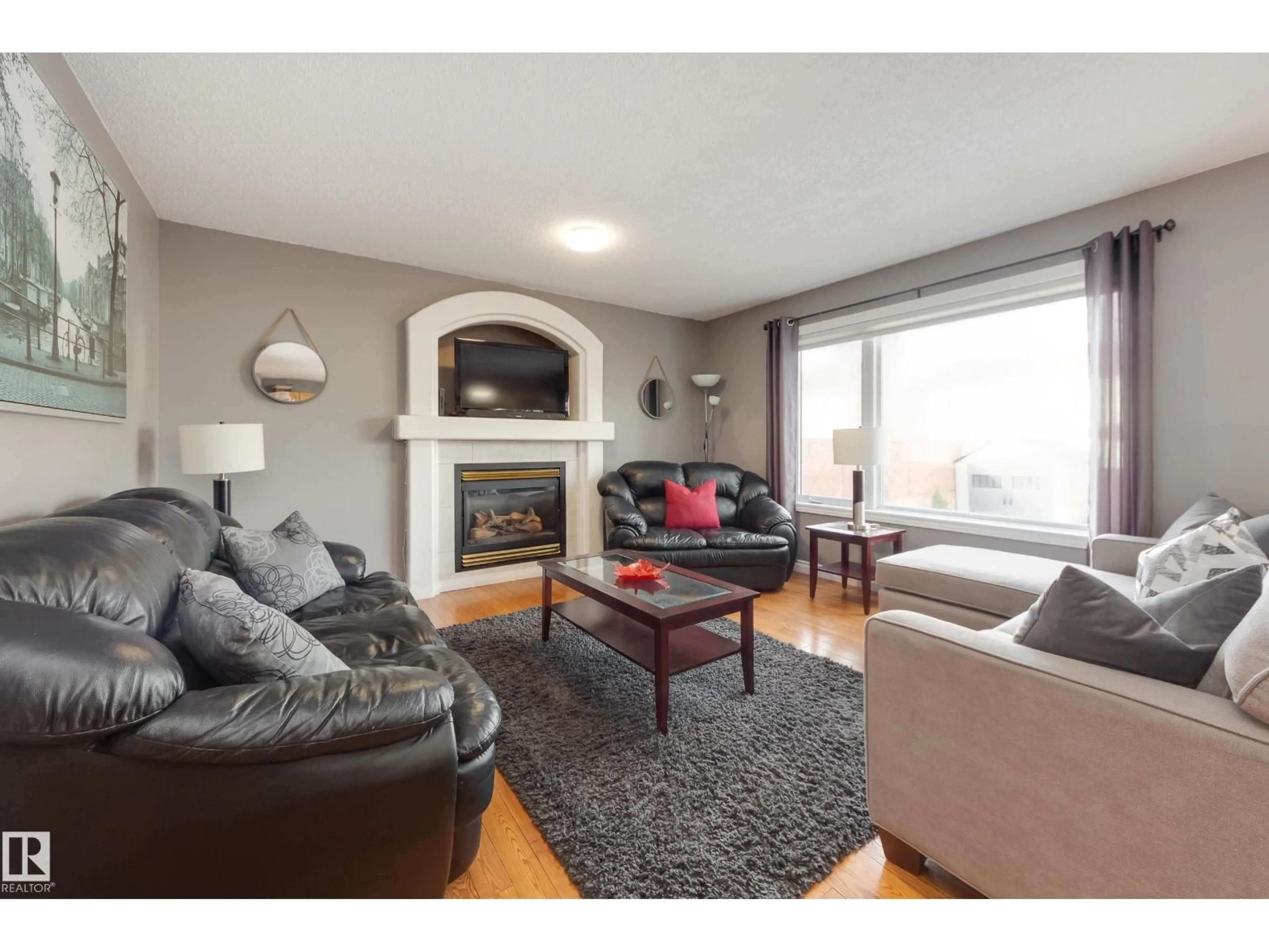 Living room with furniture, wood/laminate floor for 2844 40B AV NW, Edmonton Alberta T6T1L8