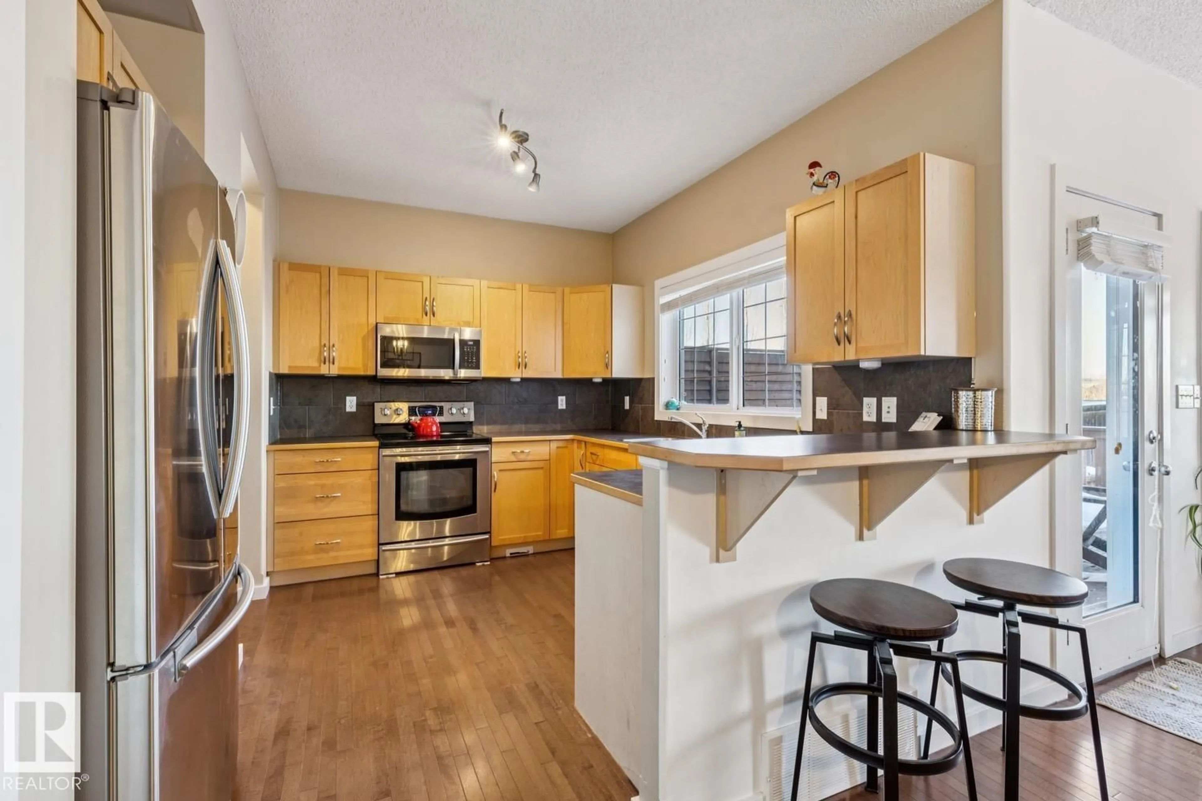 Open concept kitchen, wood/laminate floor for NW - 3127 TRELLE LO, Edmonton Alberta T6R0A1