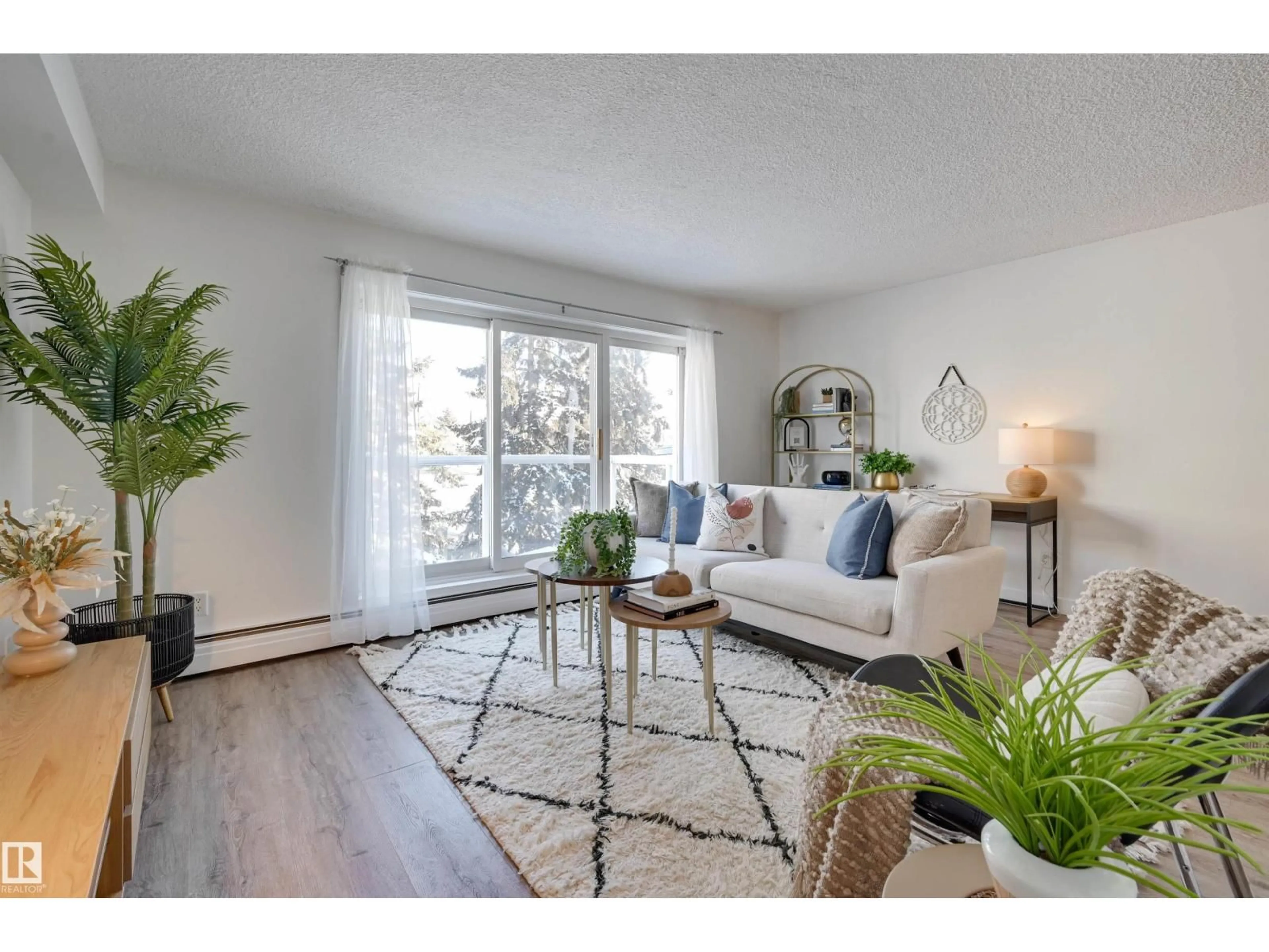 Living room with furniture, wood/laminate floor for 310 - 8215 83 AV, Edmonton Alberta T6C1A7