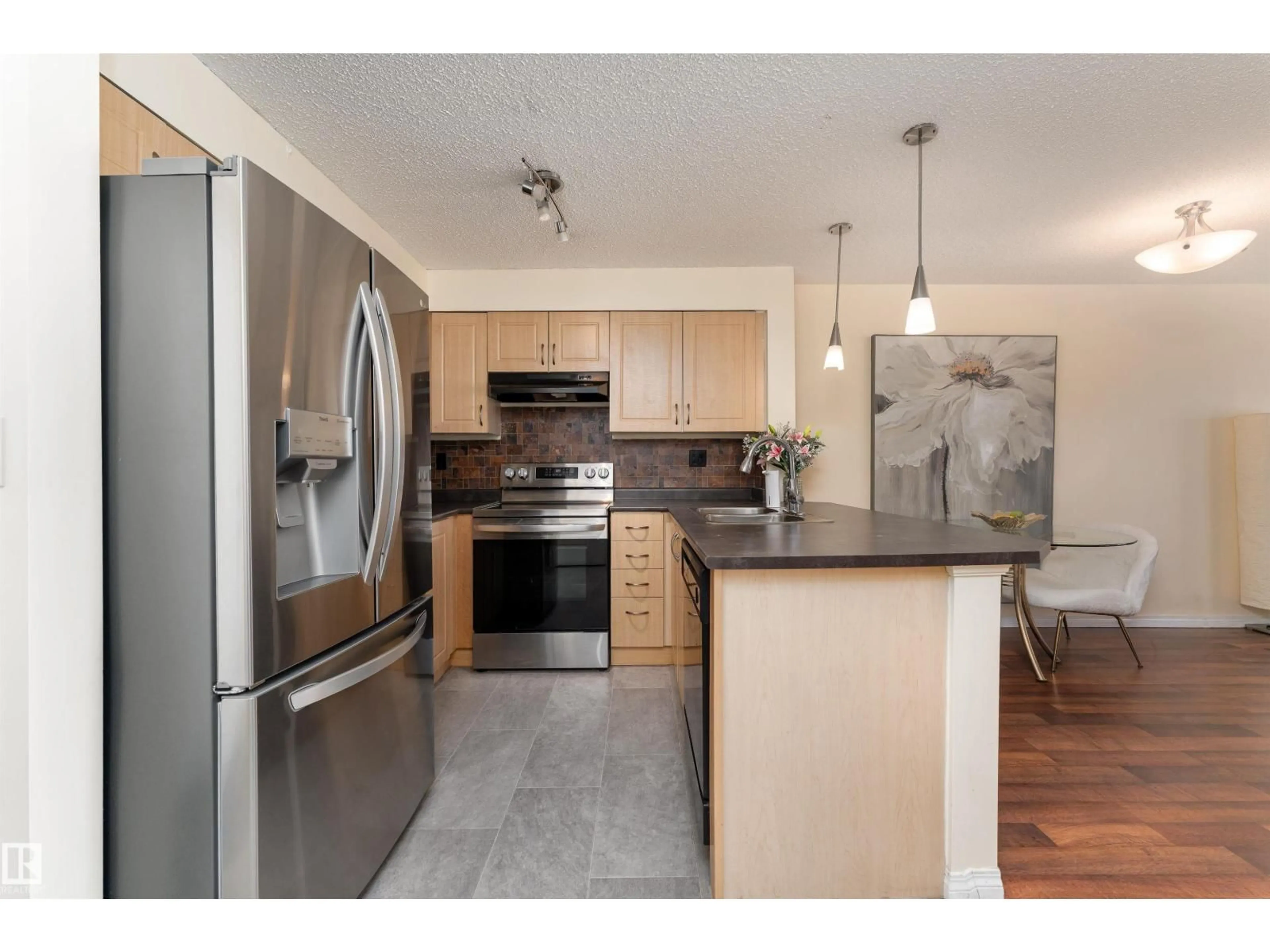 Open concept kitchen, wood/laminate floor for 11441 - 317 ELLERSLIE RD SW, Edmonton Alberta T6W1S9