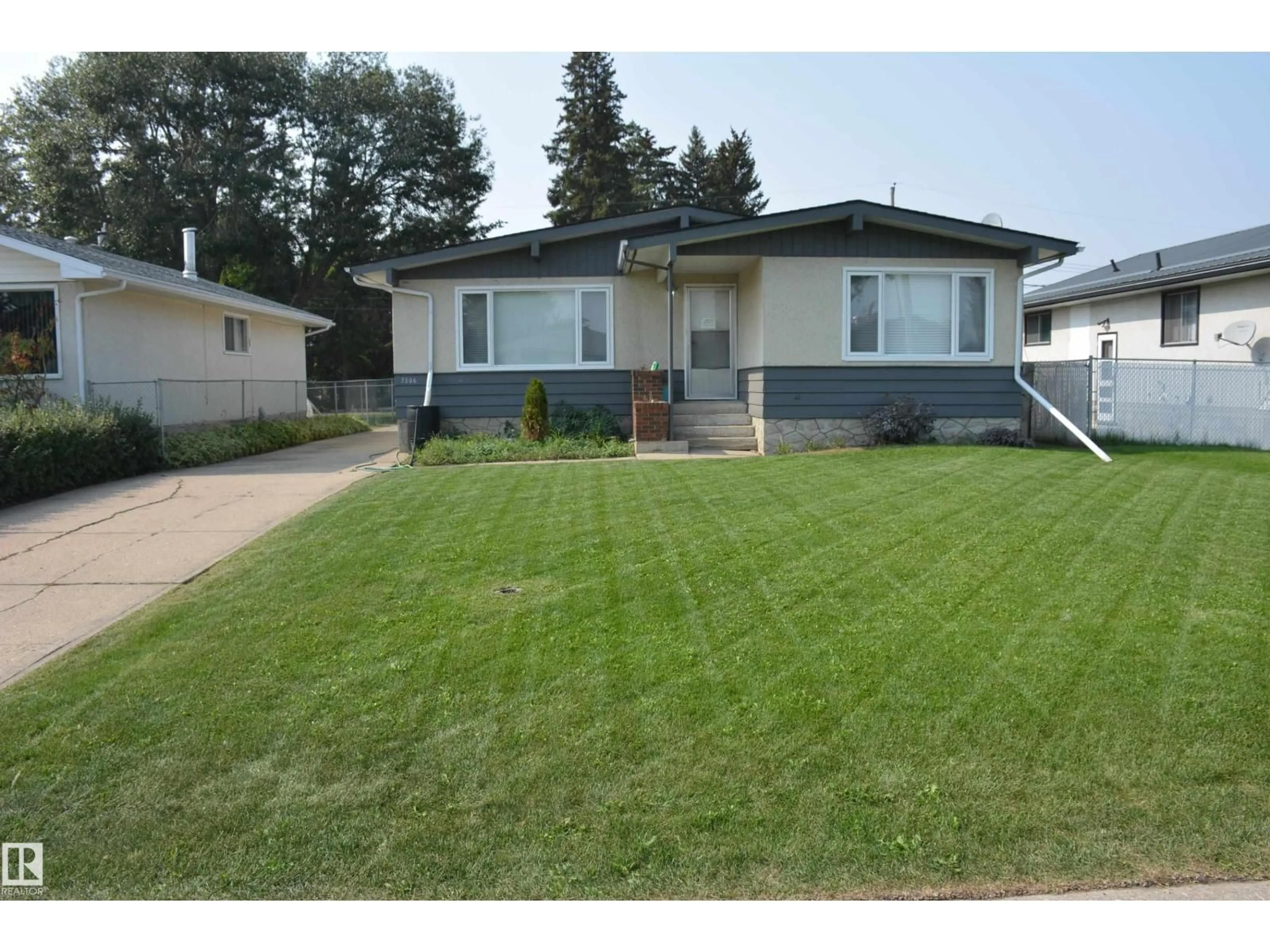 Home with vinyl exterior material, street for 5506 56 ST, Barrhead Alberta T7N1C6