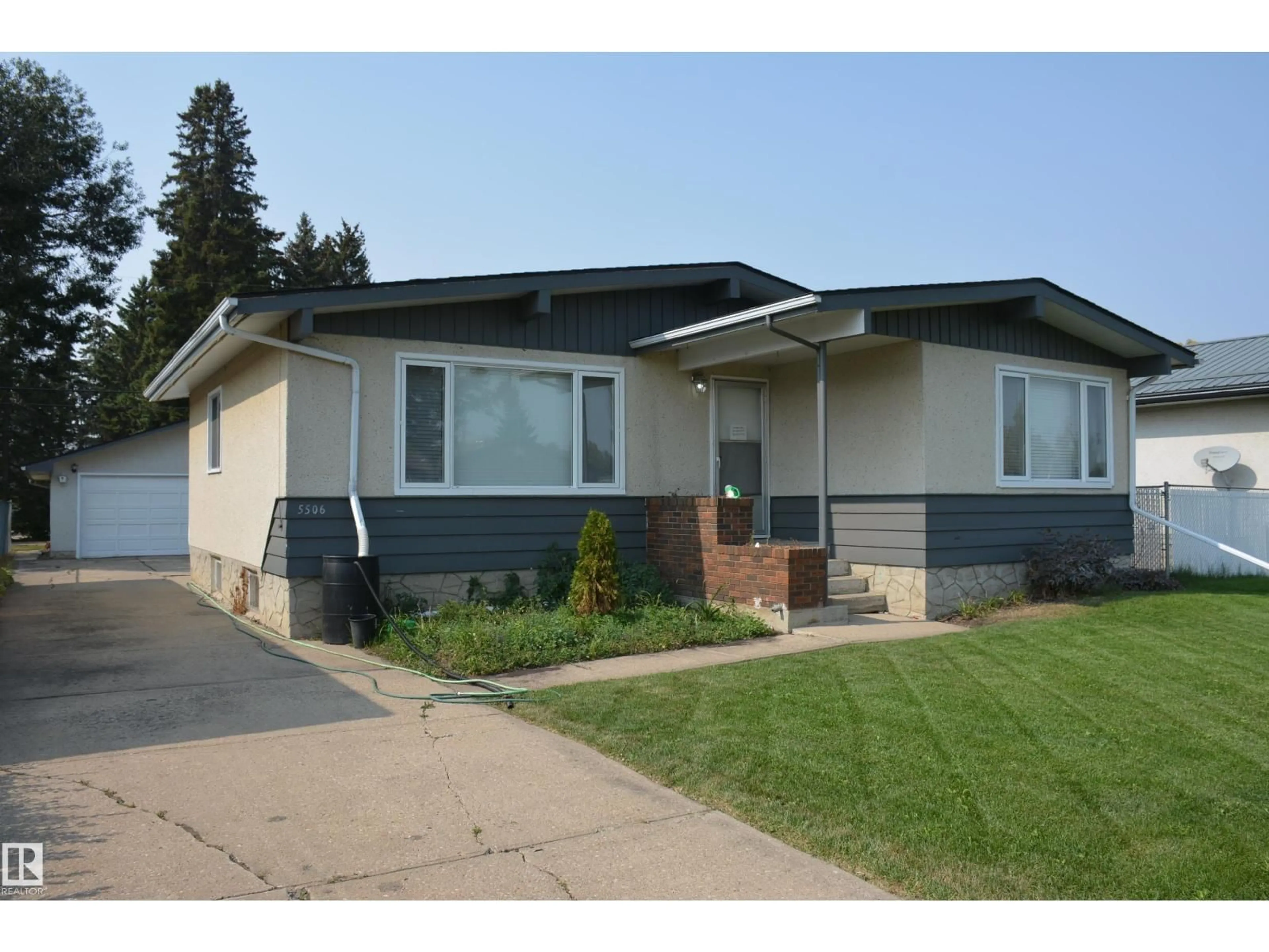 Home with vinyl exterior material, street for 5506 56 ST, Barrhead Alberta T7N1C6