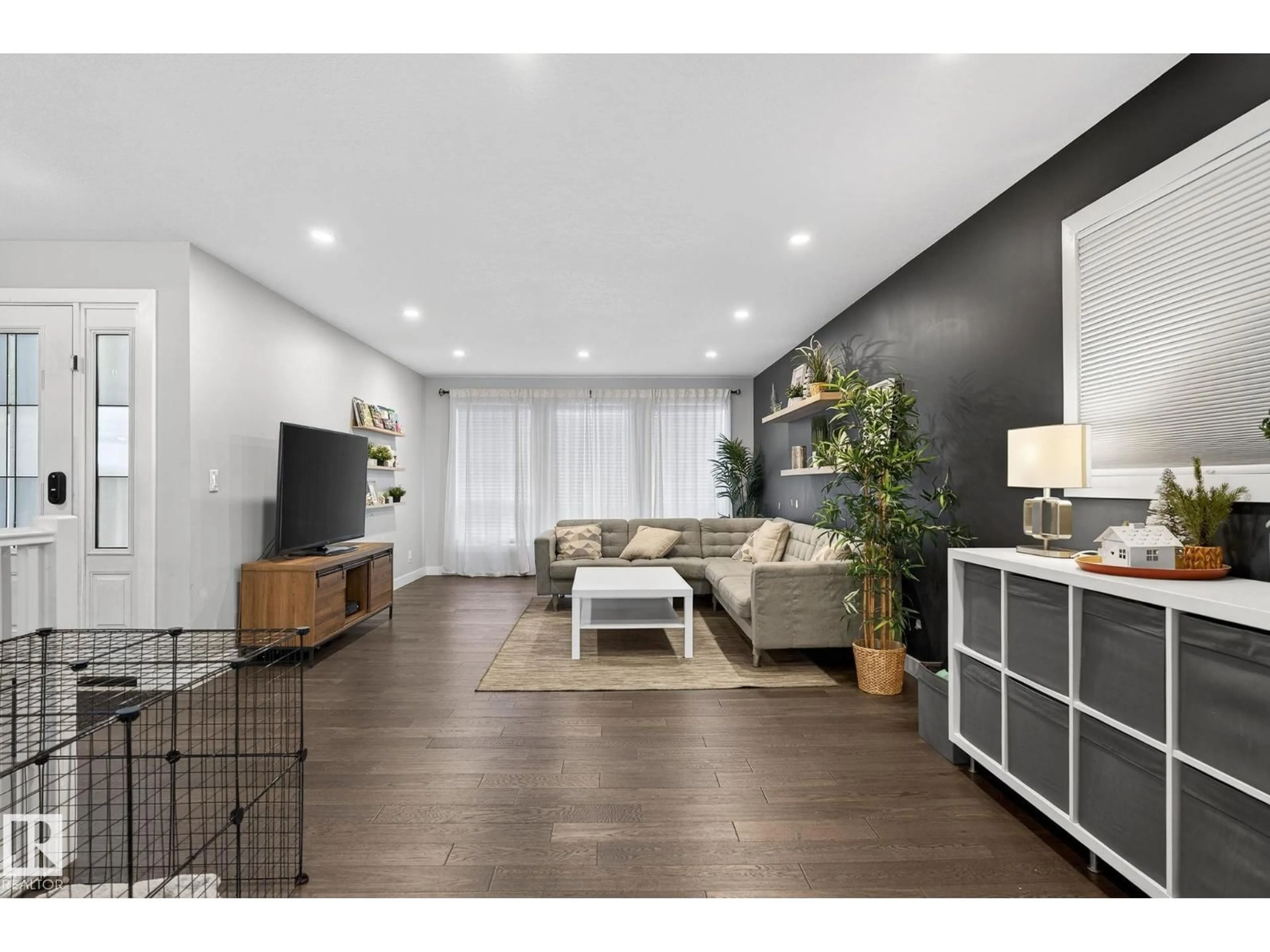 Living room with furniture, wood/laminate floor for 25 STIRLING RD, Edmonton Alberta T5X4C2