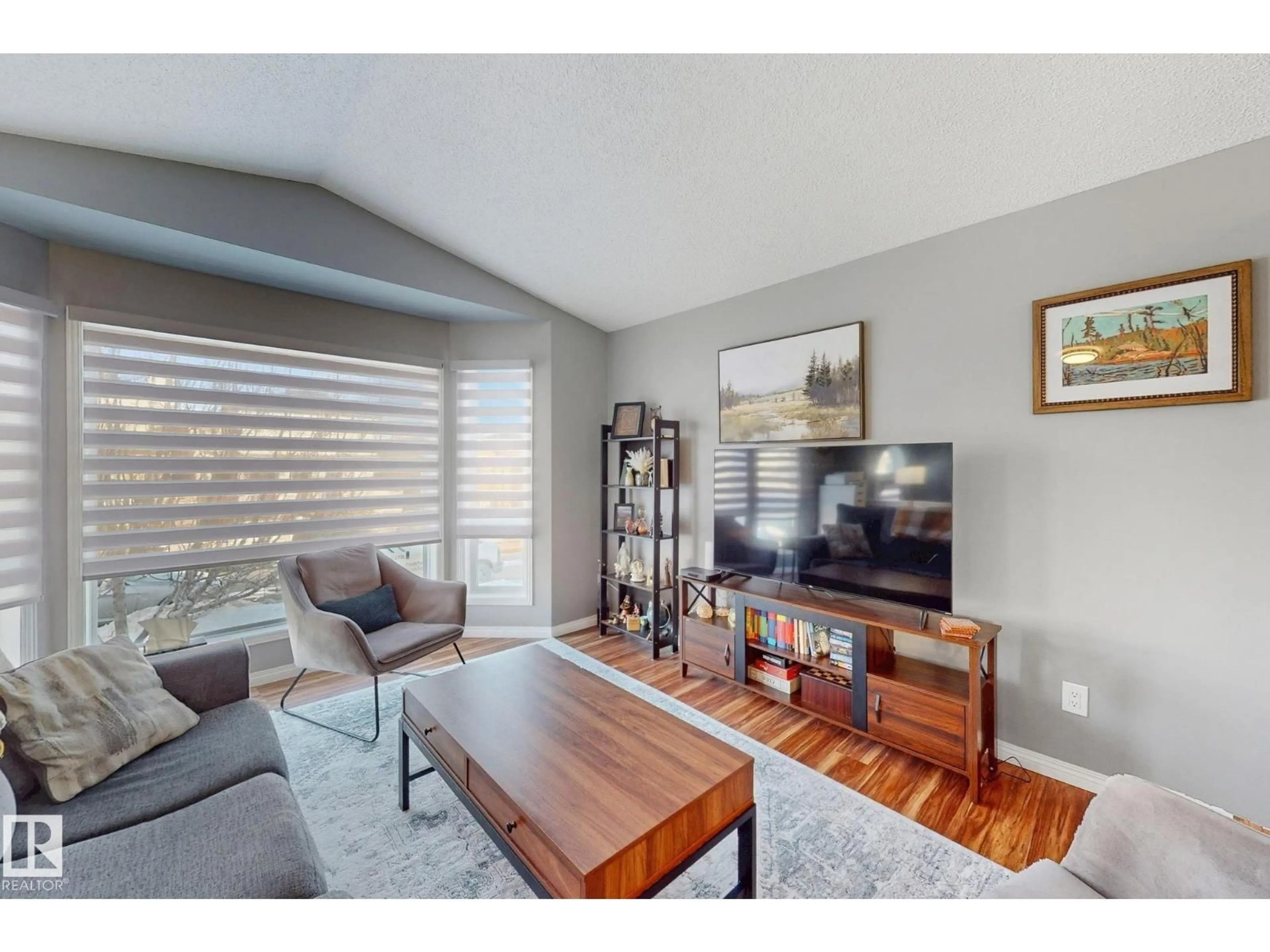Living room with furniture, wood/laminate floor for 4515 149 AV, Edmonton Alberta T5Y2Y9