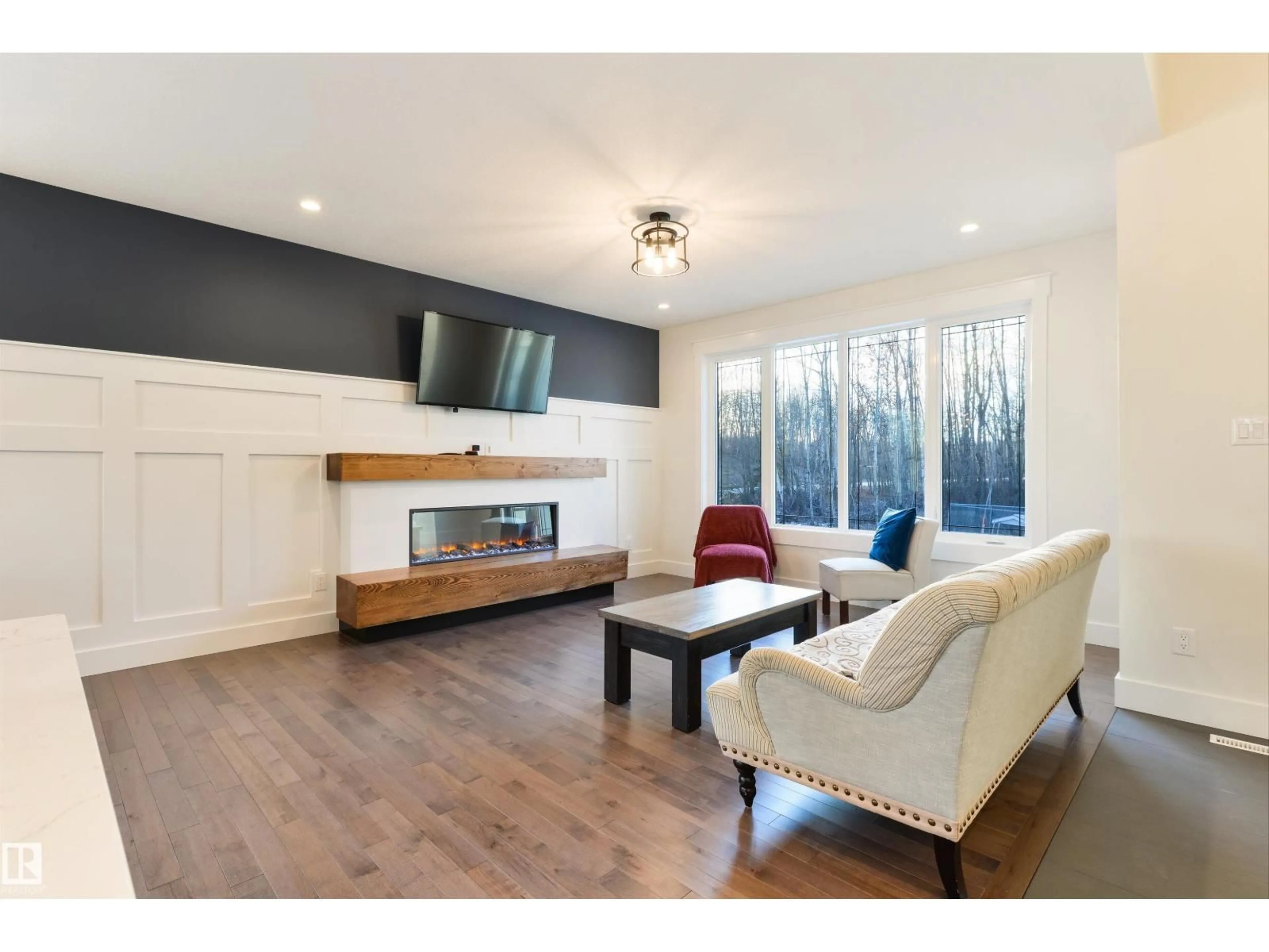 Living room with furniture, wood/laminate floor for 14 - 2406 TWP ROAD 540, Rural Lac Ste. Anne County Alberta T0E1V0