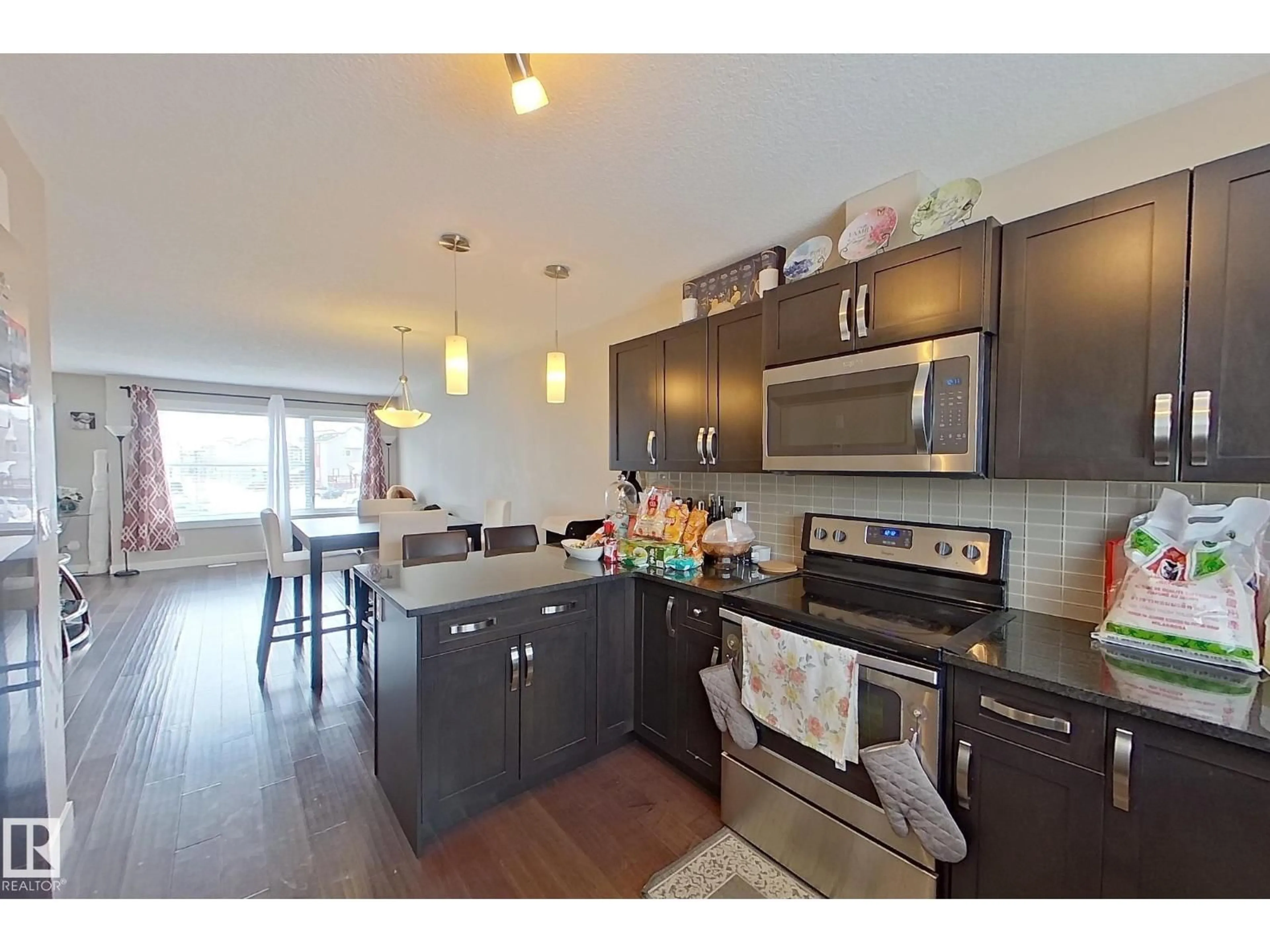 Open concept kitchen, wood/laminate floor for 401 - 295 SOUTHFORK DR, Leduc Alberta T6L5T2