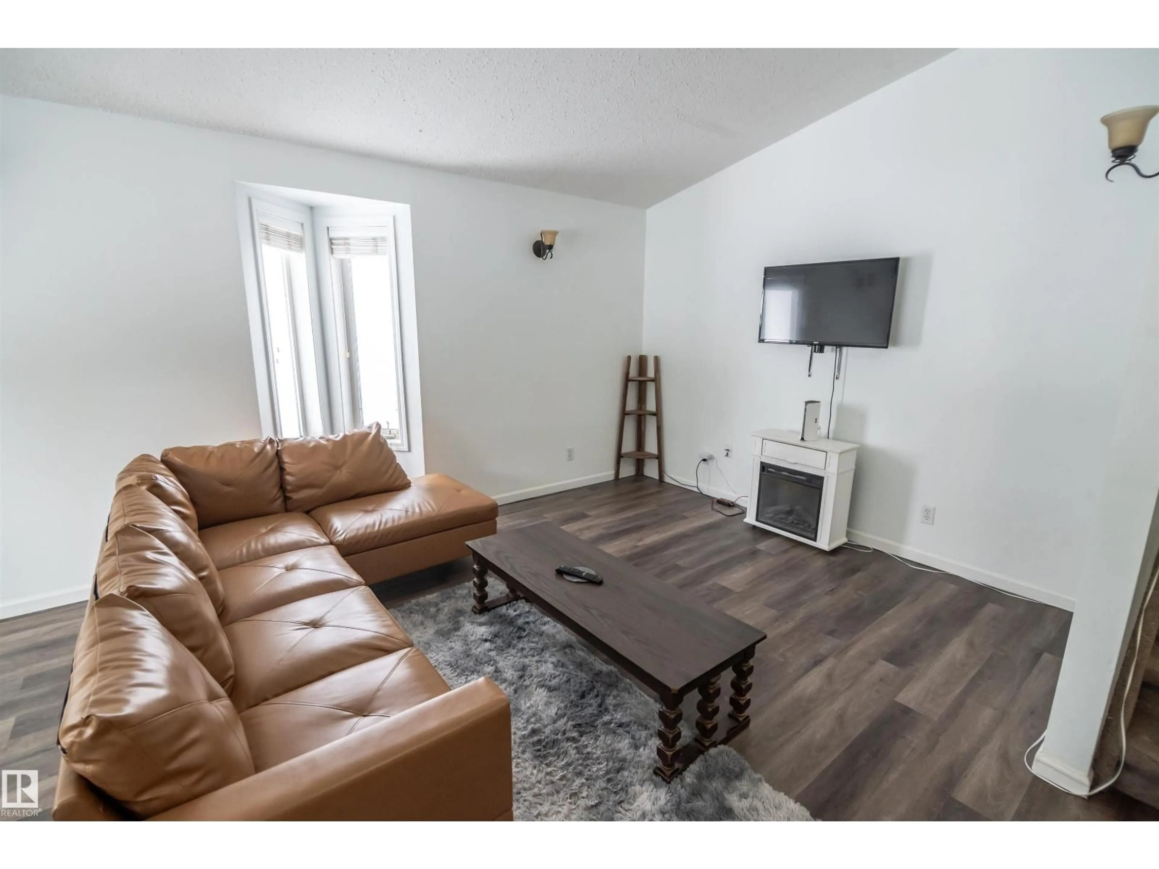 Living room with furniture, wood/laminate floor for 4727 52A ST, Rural Lac Ste. Anne County Alberta T0E0A0