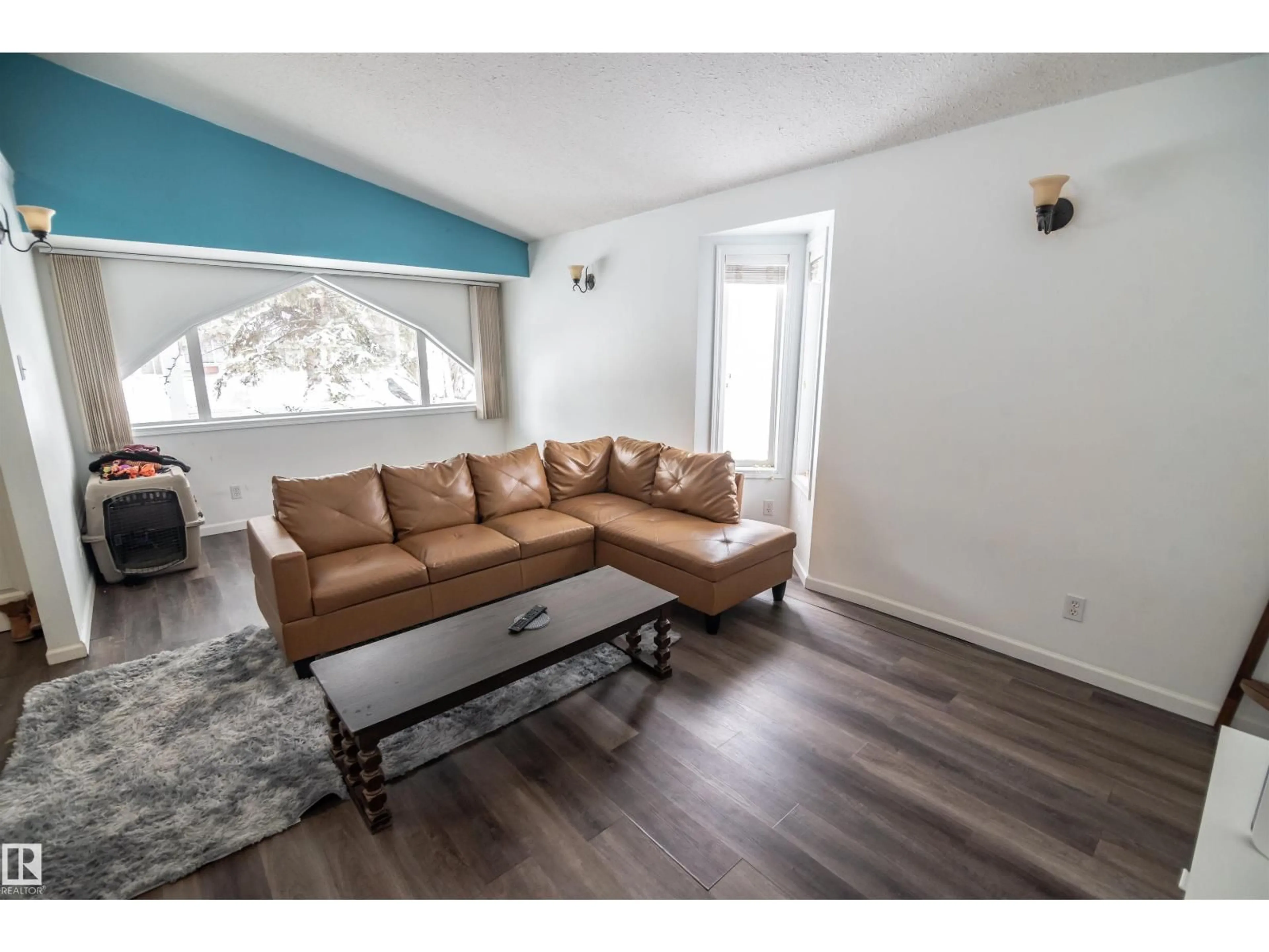 Living room with furniture, wood/laminate floor for 4727 52A ST, Rural Lac Ste. Anne County Alberta T0E0A0
