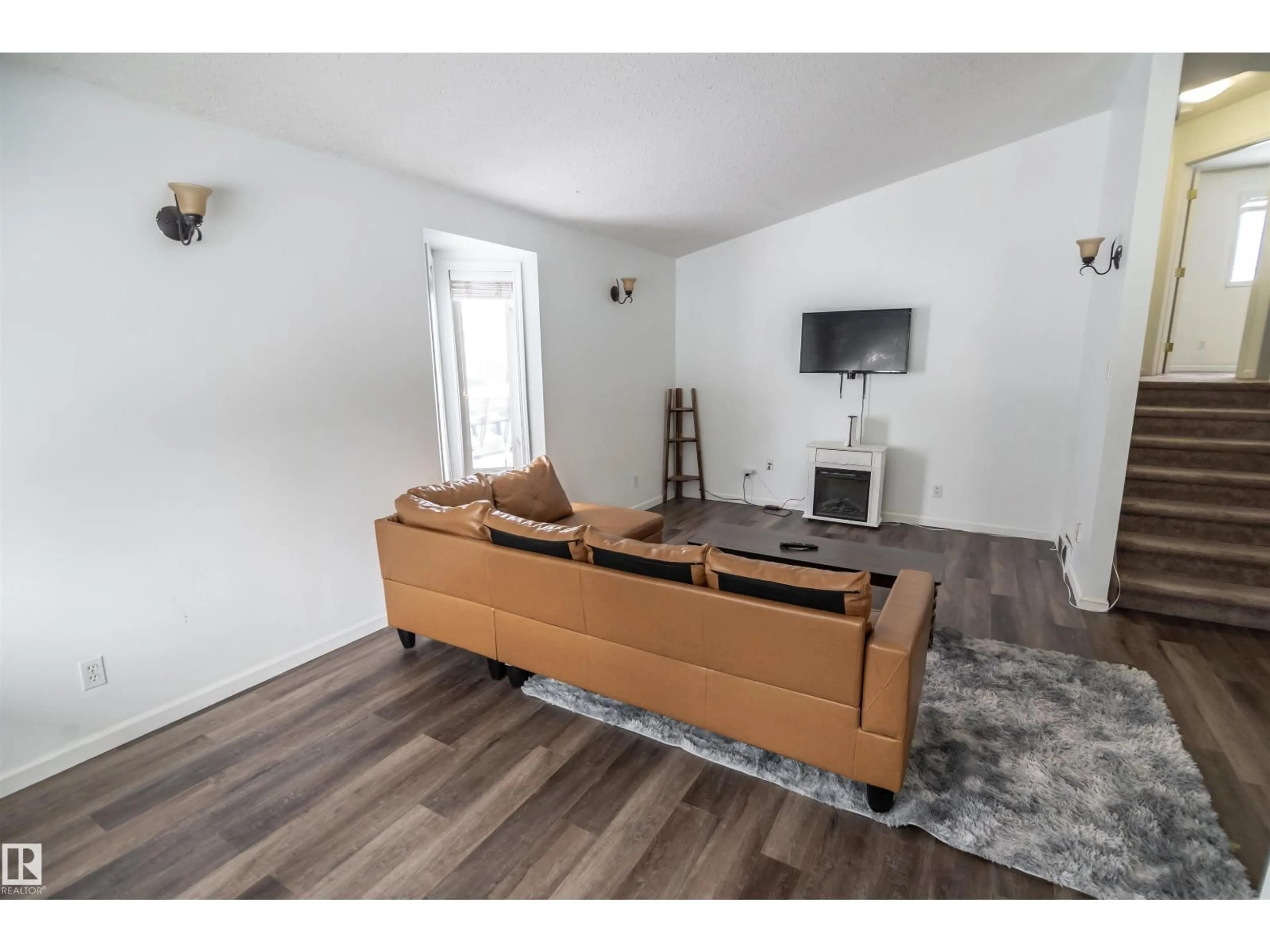 Living room with furniture, wood/laminate floor for 4727 52A ST, Rural Lac Ste. Anne County Alberta T0E0A0