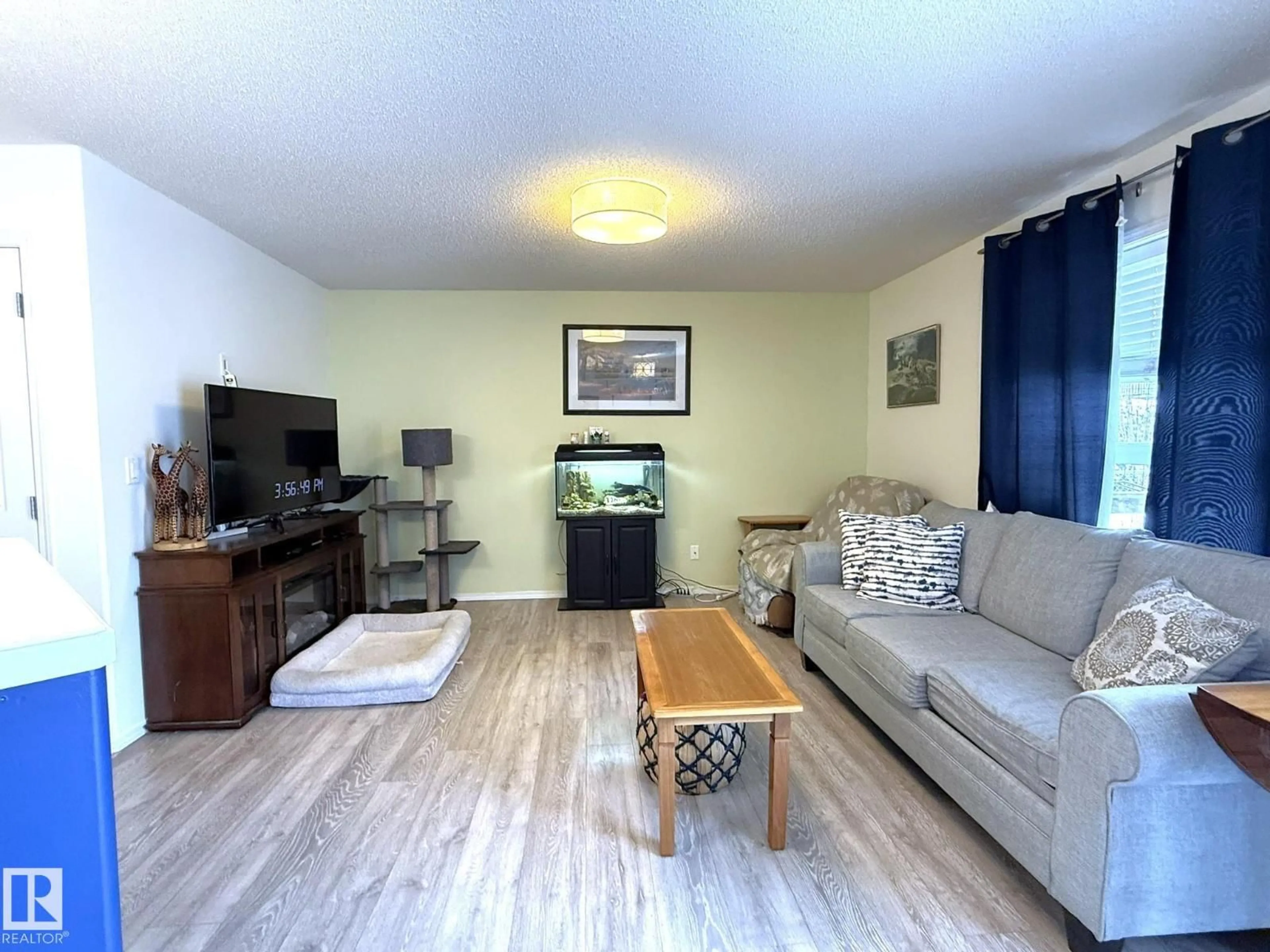 Living room with furniture, wood/laminate floor for 735 KANANASKIS DR, Devon Alberta T9G2G7