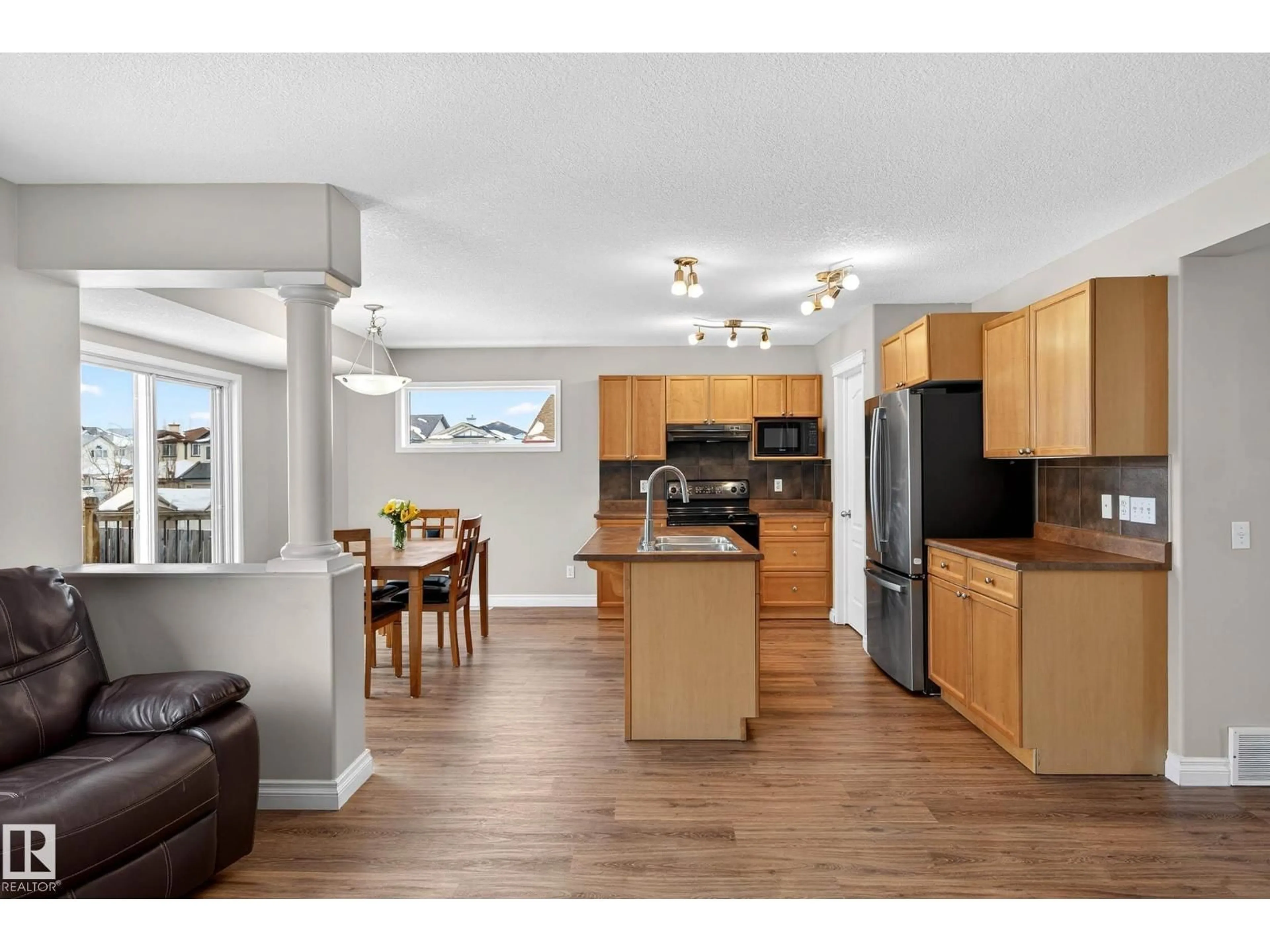 Open concept kitchen, wood/laminate floor for 4214 156A AV, Edmonton Alberta T5Y0C9