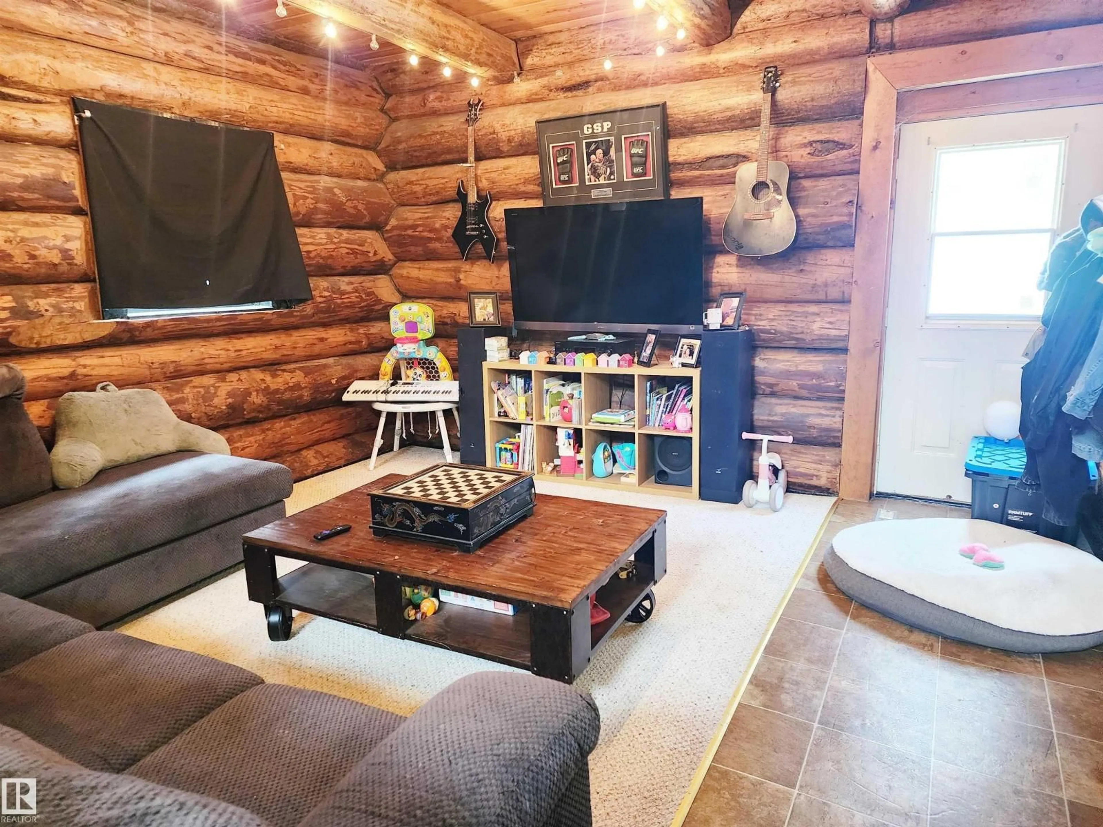 Living room with furniture, wood/laminate floor for 37 - 61076 TWP ROAD 462 A, Rural Wetaskiwin County Alberta T0C0T0