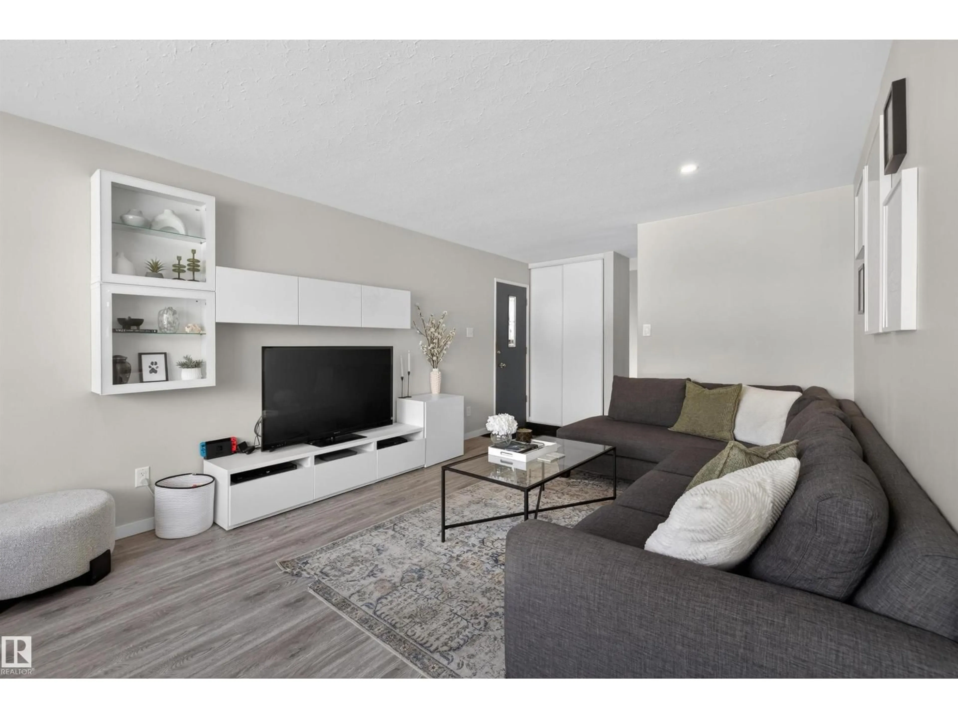 Living room with furniture, wood/laminate floor for 7719 71 AV, Edmonton Alberta T6C0A9