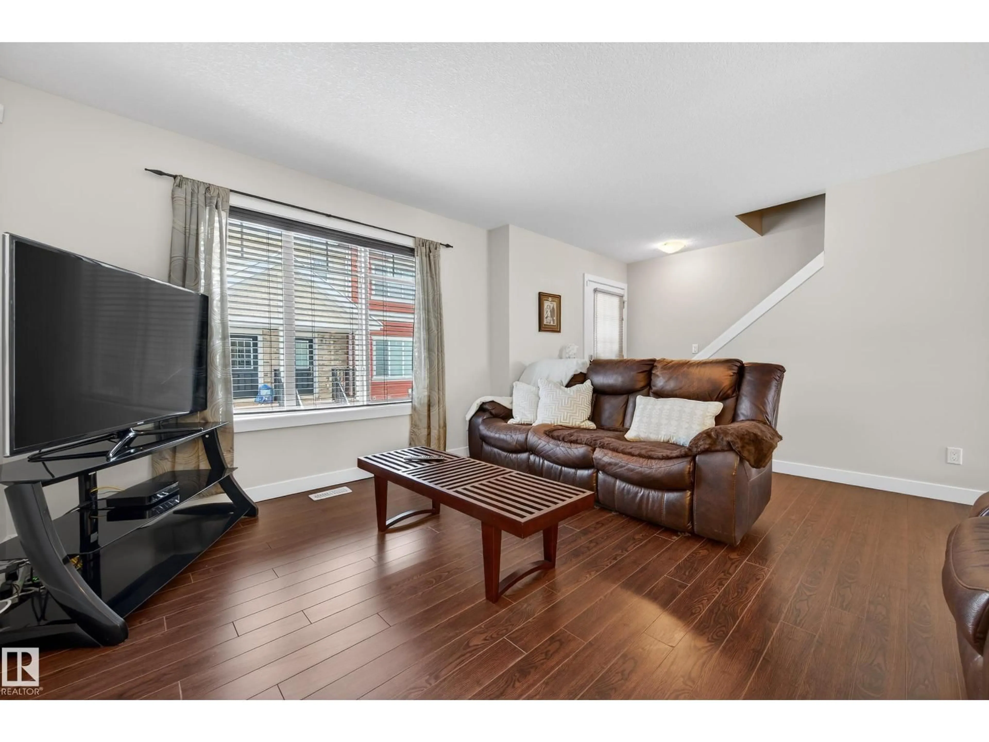 Living room with furniture, wood/laminate floor for 5134 - 20 MULLEN RD, Edmonton Alberta T6R0S7