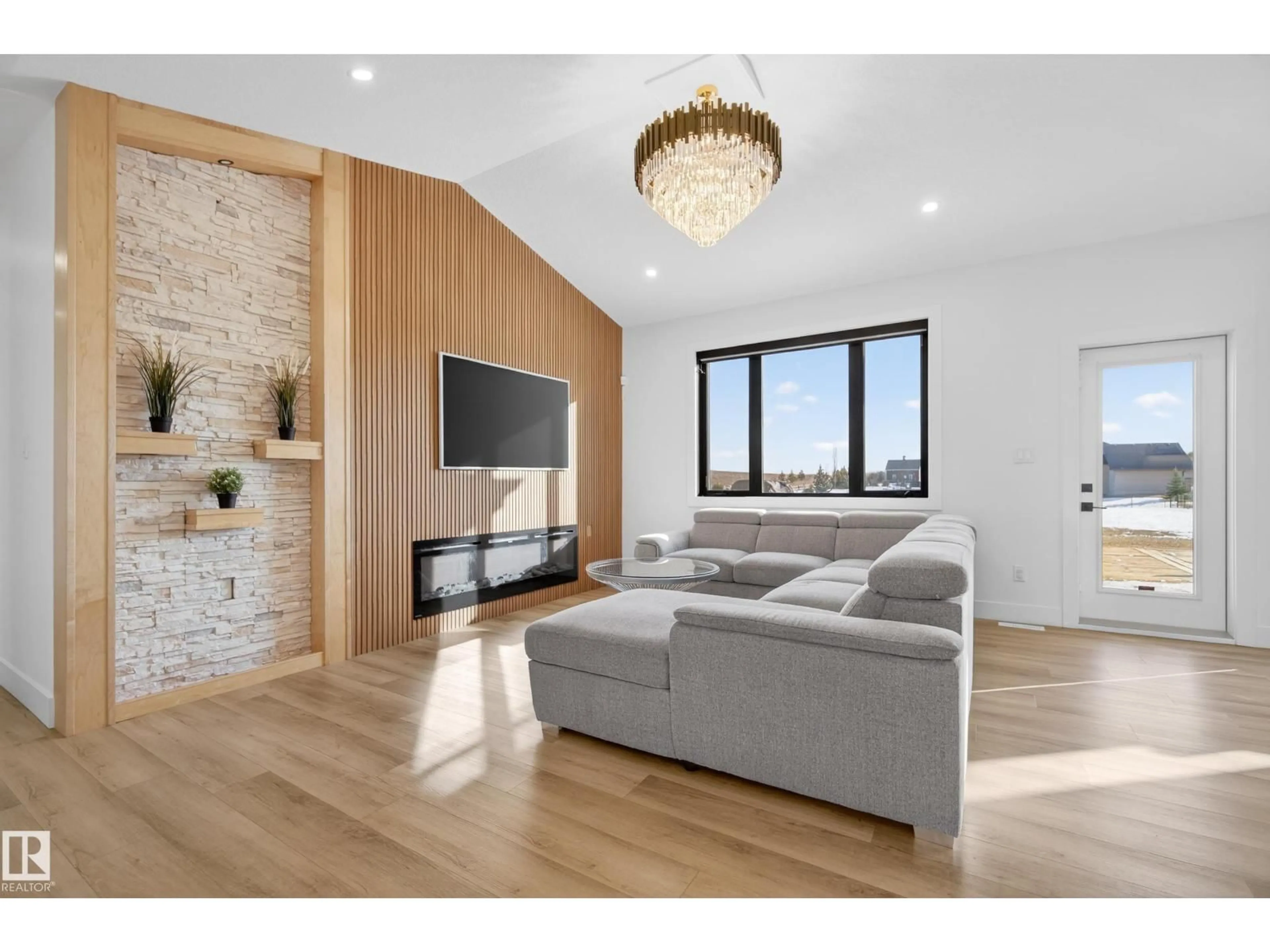 Living room with furniture, wood/laminate floor for 52 25527 TWP ROAD 511 A, Rural Parkland County Alberta T7Y1A8