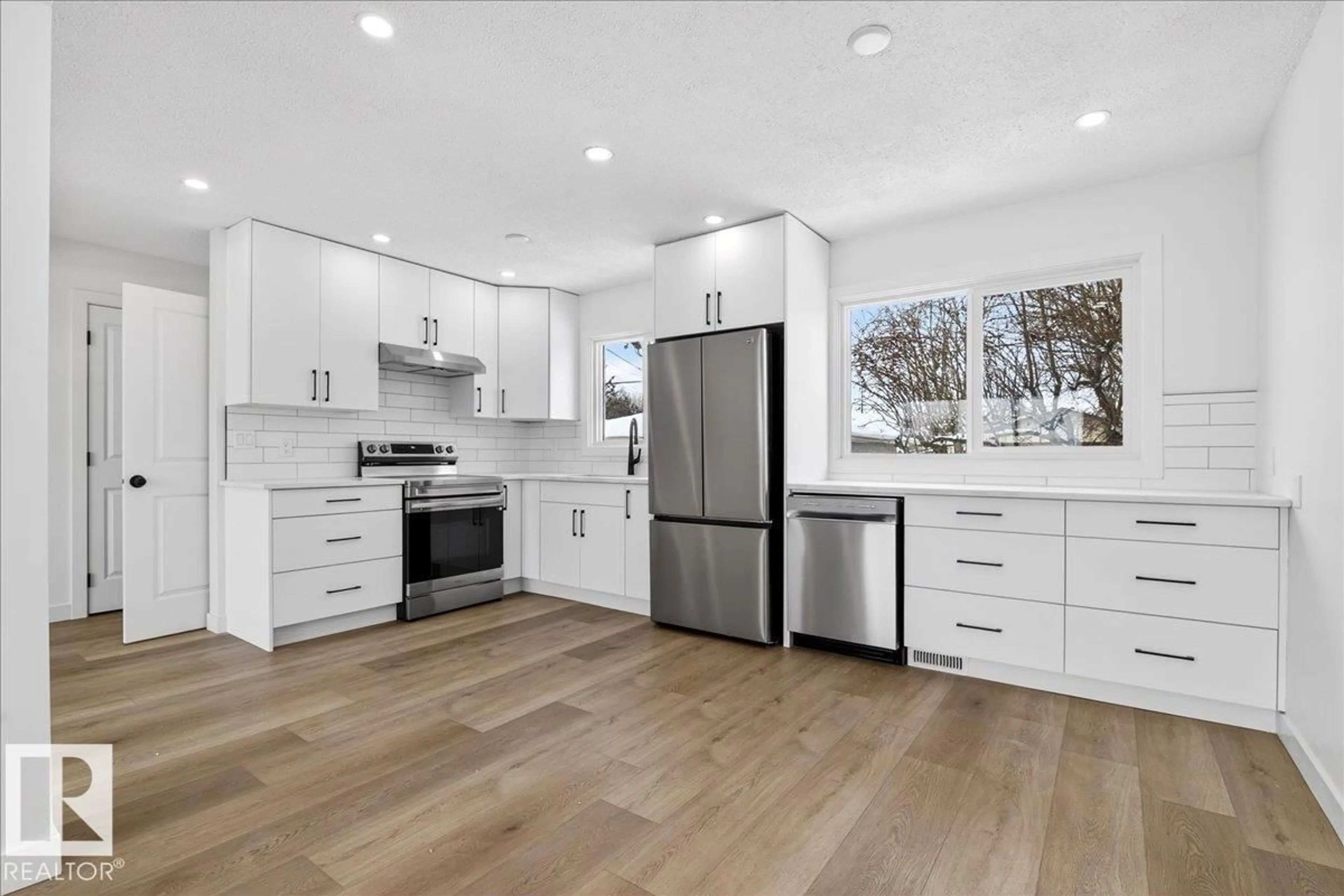 Open concept kitchen, wood/laminate floor for NW - 13212 121 ST, Edmonton Alberta T5L0B8