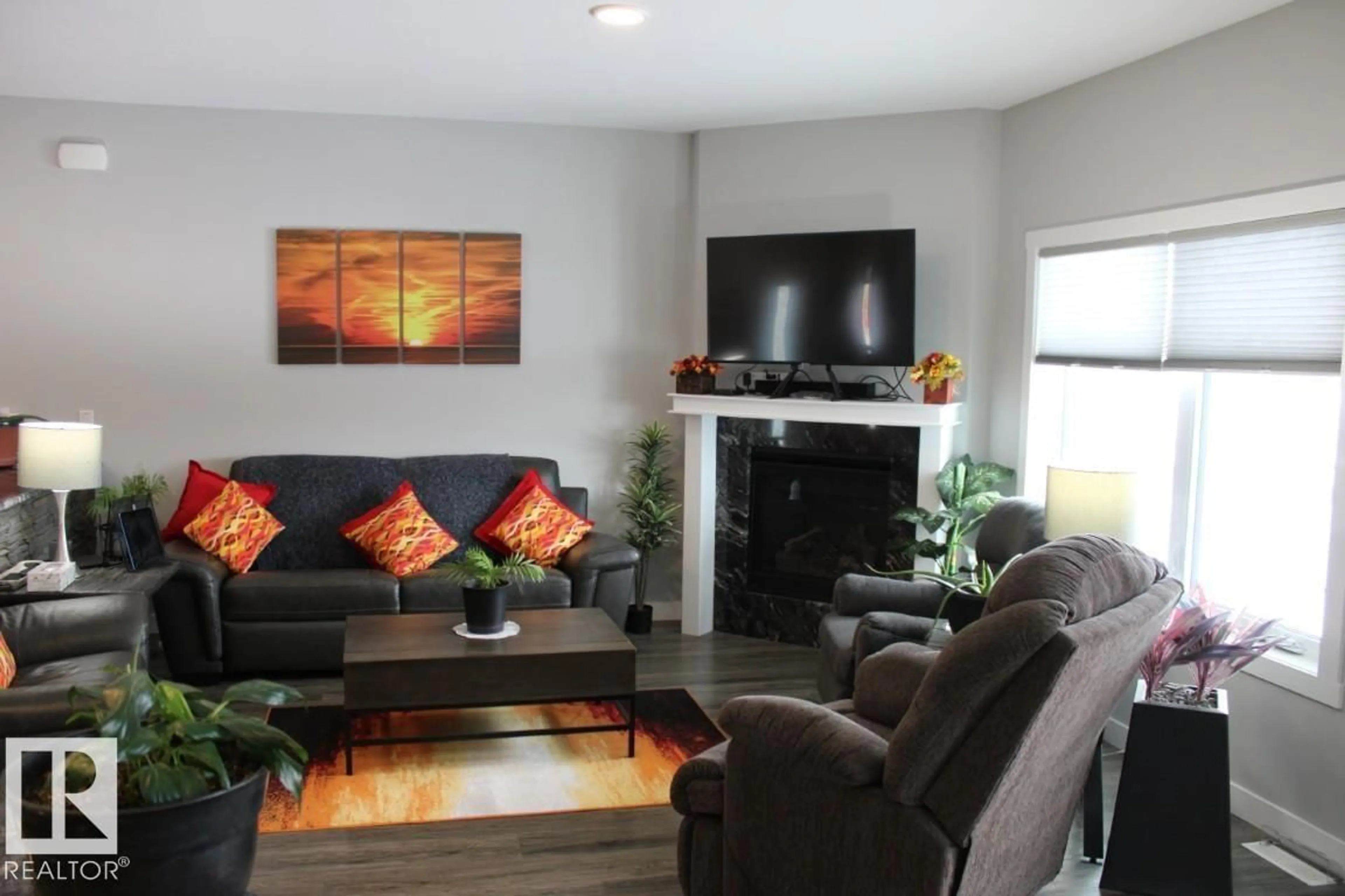 Living room with furniture, wood/laminate floor for 22 - 6519 46 ST, Wetaskiwin Alberta T9A1Y5