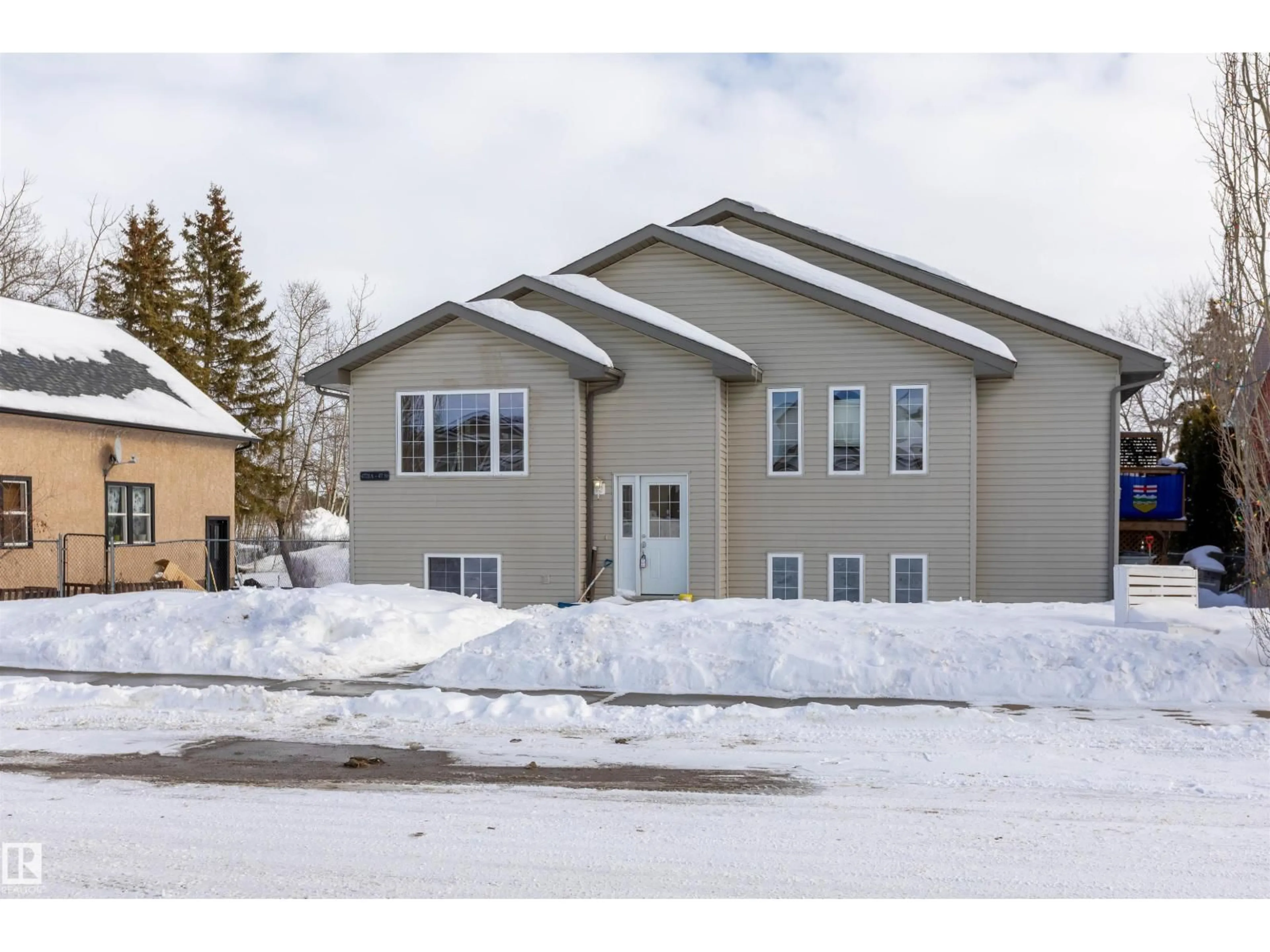 Home with vinyl exterior material, street for 4721A 47 ST, Legal Alberta T0G1L0