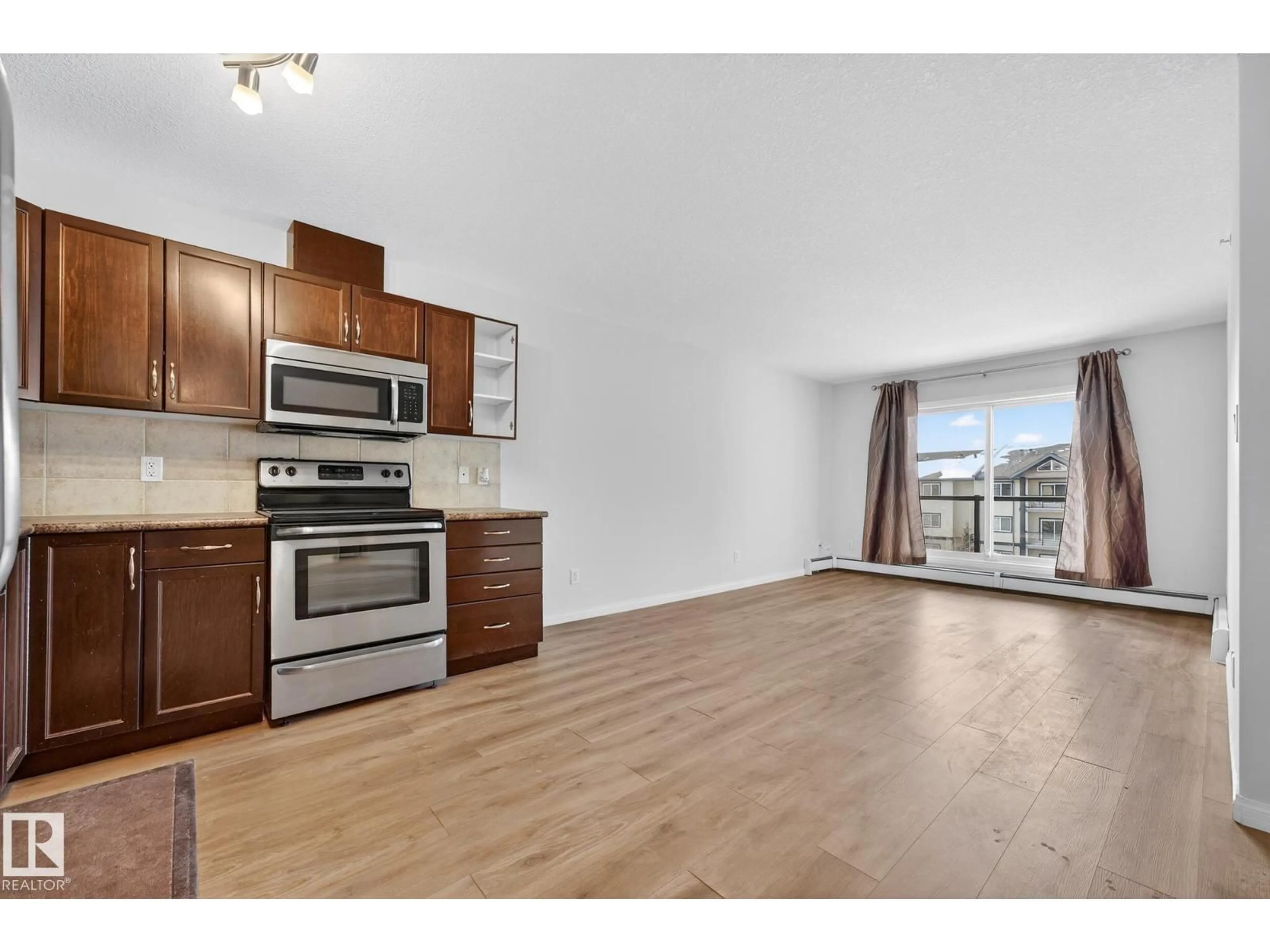 Open concept kitchen, wood/laminate floor for #416 - 1204 156 ST, Edmonton Alberta T6R0R6