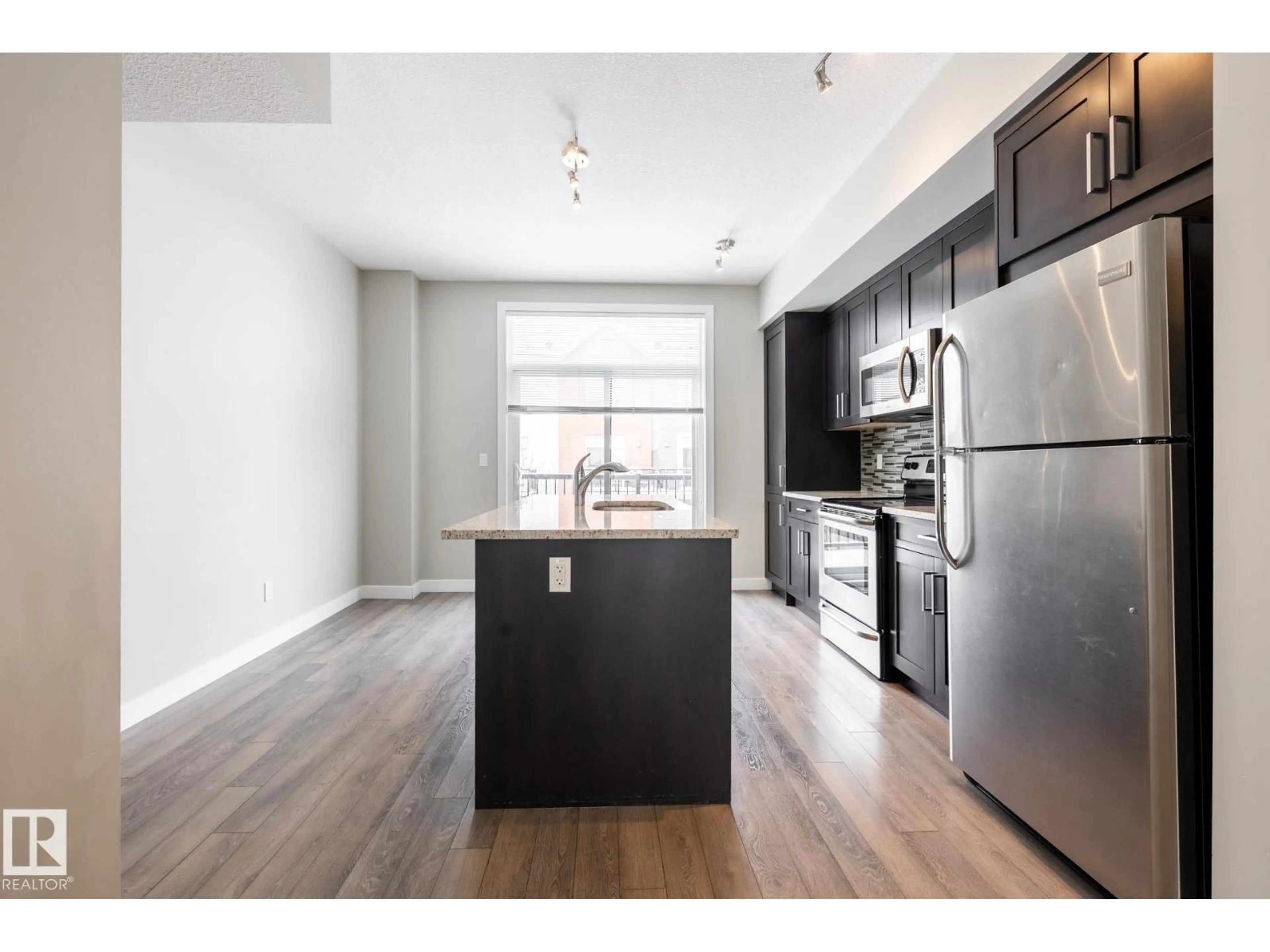 Open concept kitchen, wood/laminate floor for 127 2560 PEGASUS BV, Edmonton Alberta T5E6V4