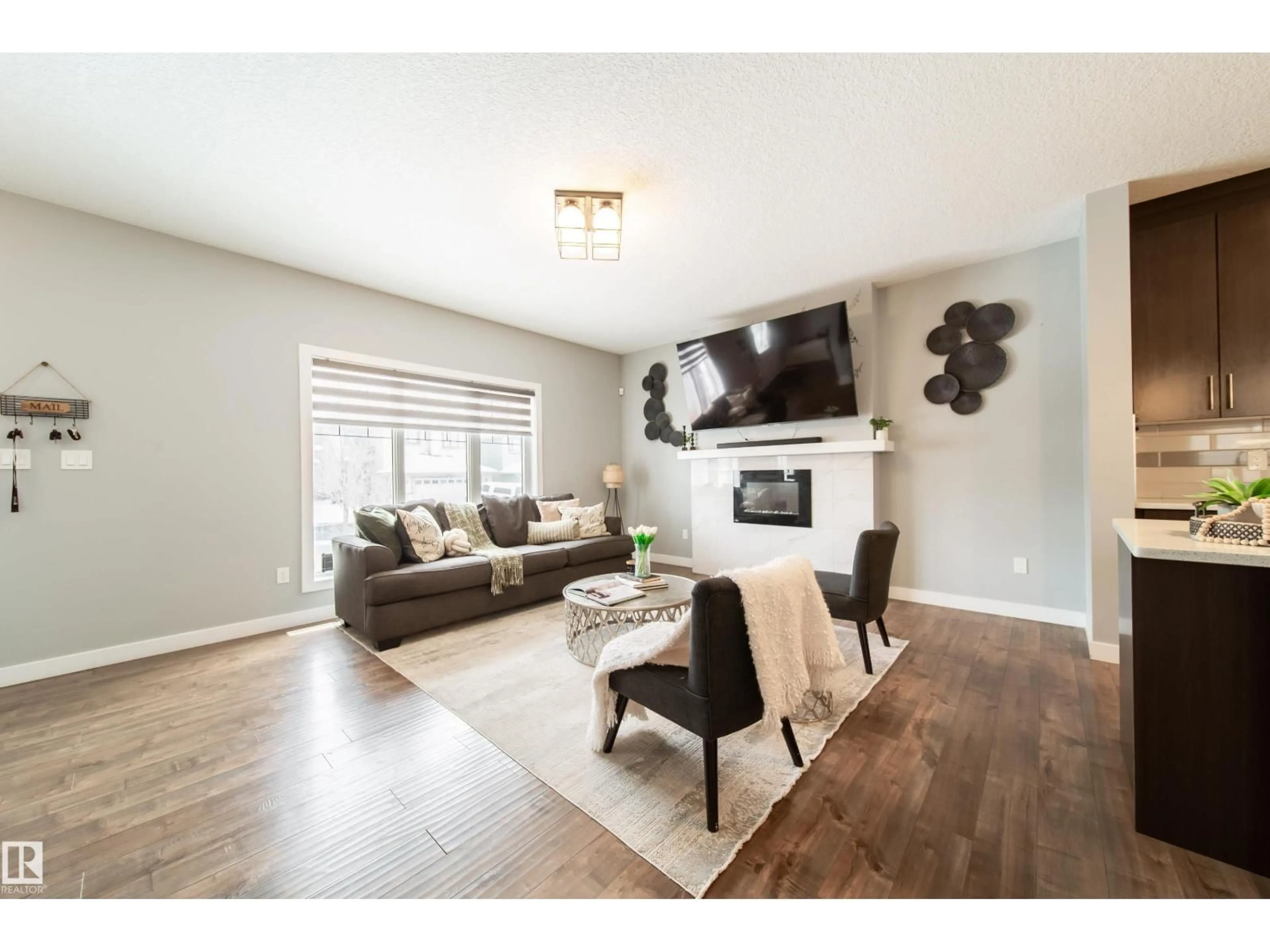 Living room with furniture, wood/laminate floor for 2716 11 ST, Edmonton Alberta T6T0X9
