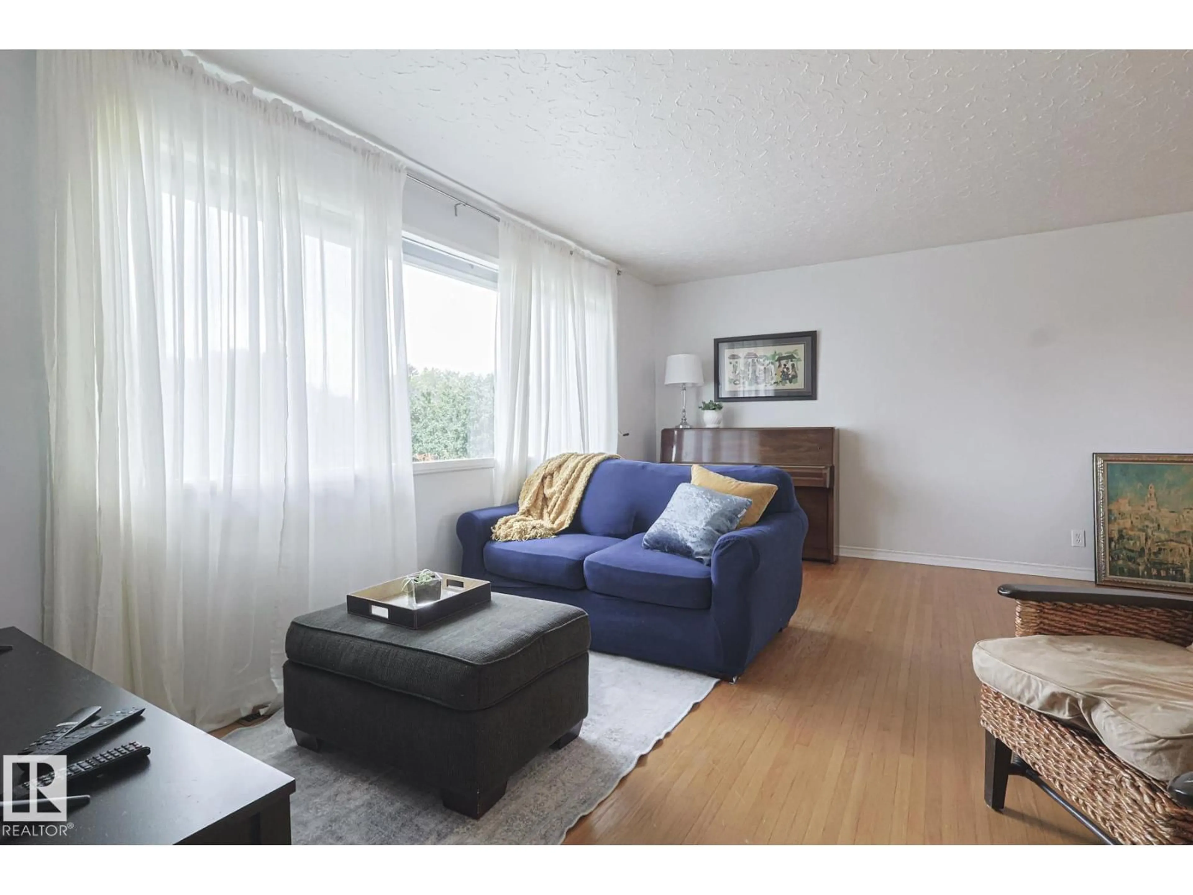 Living room with furniture, wood/laminate floor for NW - 10319 45 ST, Edmonton Alberta T6A1W8