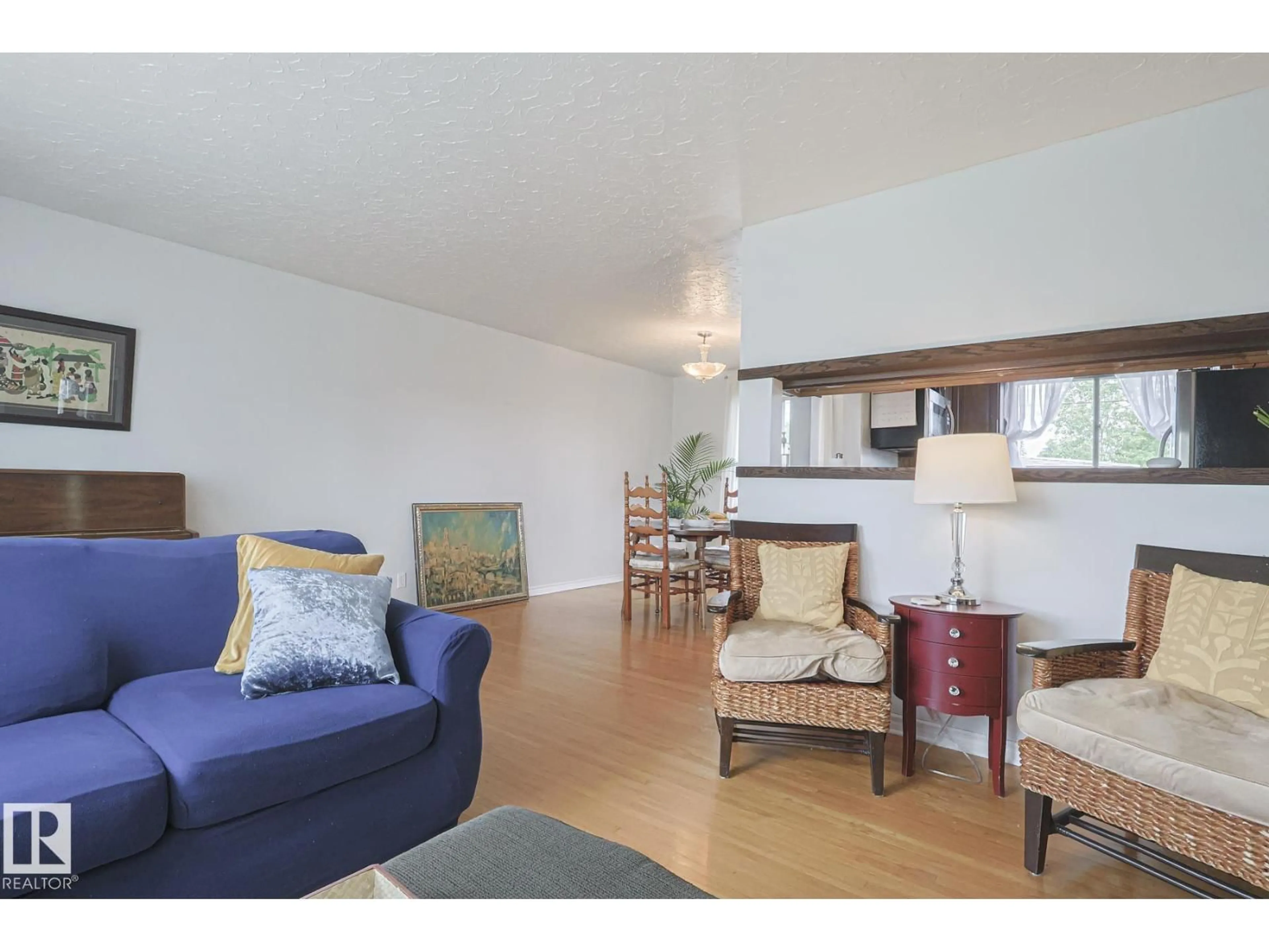 Living room with furniture, wood/laminate floor for NW - 10319 45 ST, Edmonton Alberta T6A1W8