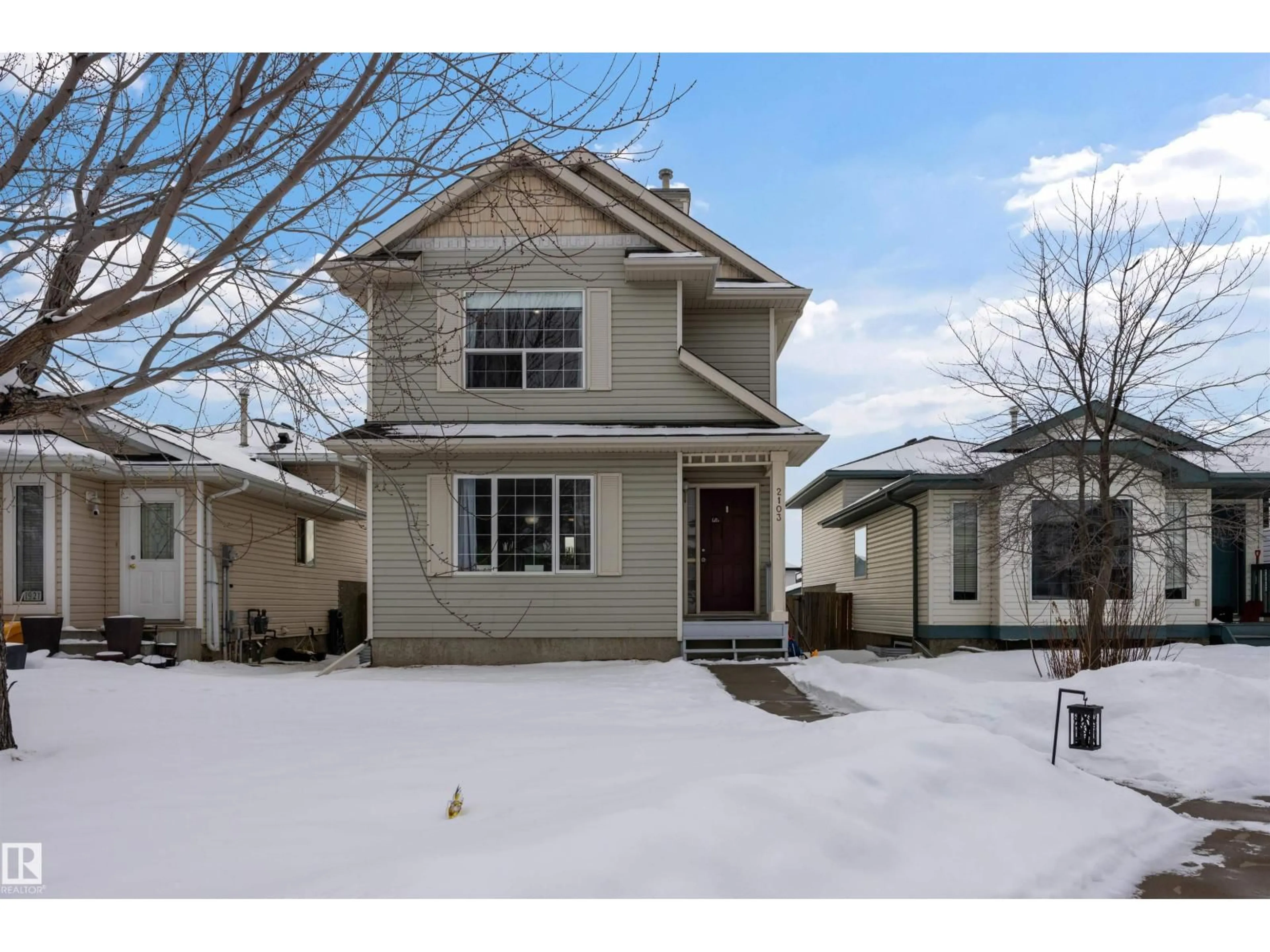 Home with vinyl exterior material, street for 2103 36 AV NW, Edmonton Alberta T6T1S3