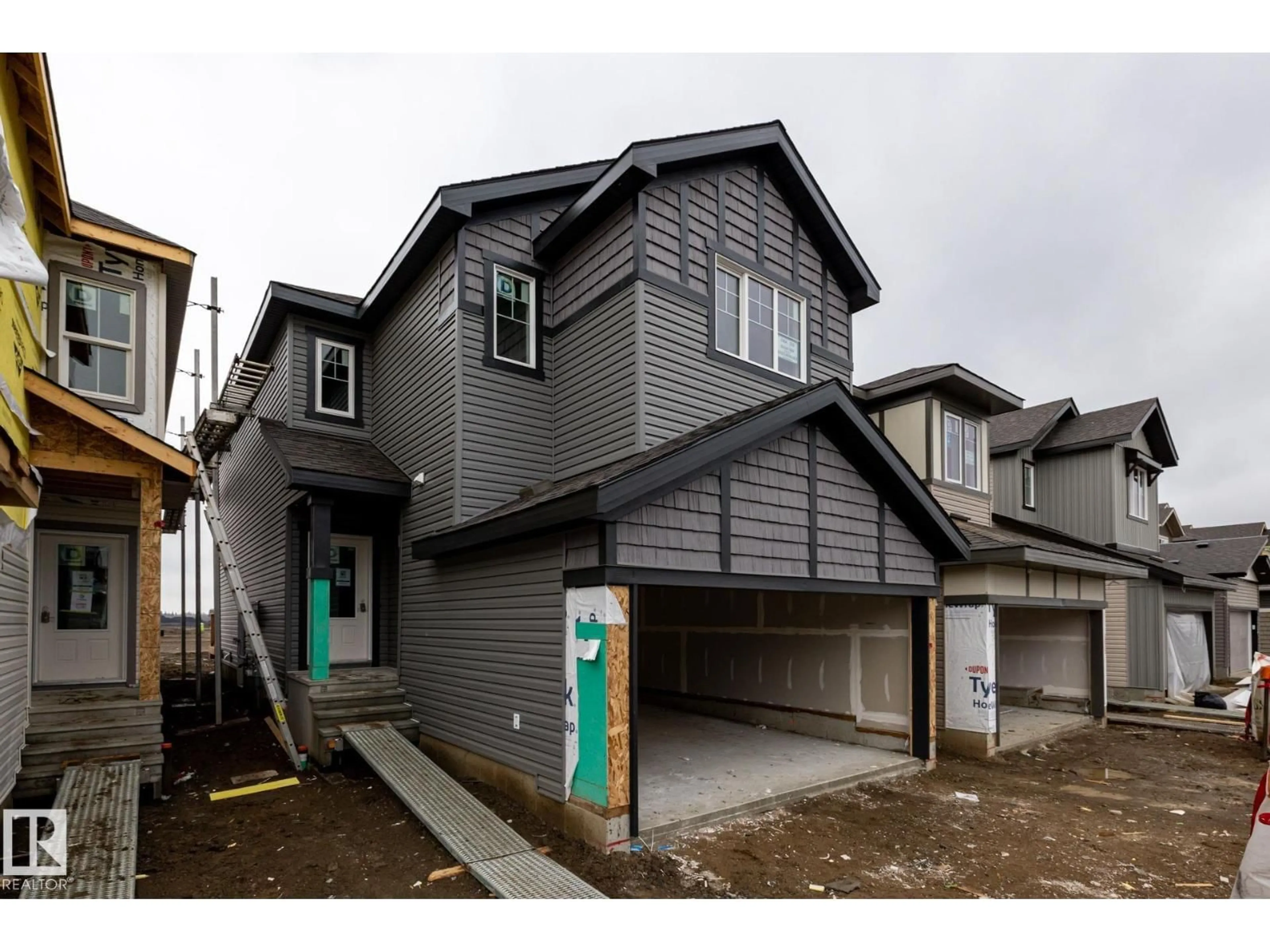 Home with vinyl exterior material, street for NW - 1964 210 ST, Edmonton Alberta T6M3H7