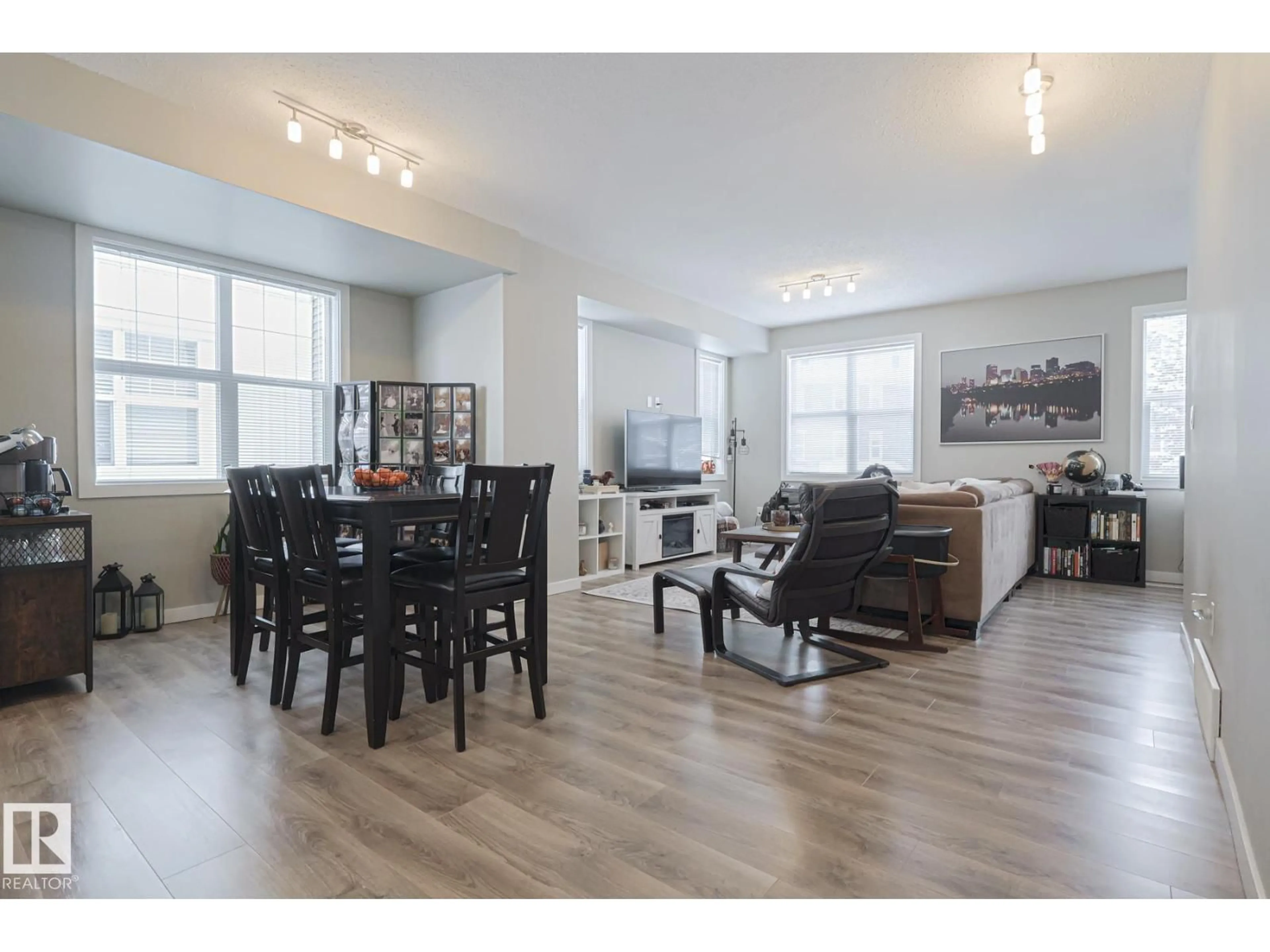 Living room with furniture, wood/laminate floor for #103 - 2803 JAMES MOWATT TR, Edmonton Alberta T6W2P5