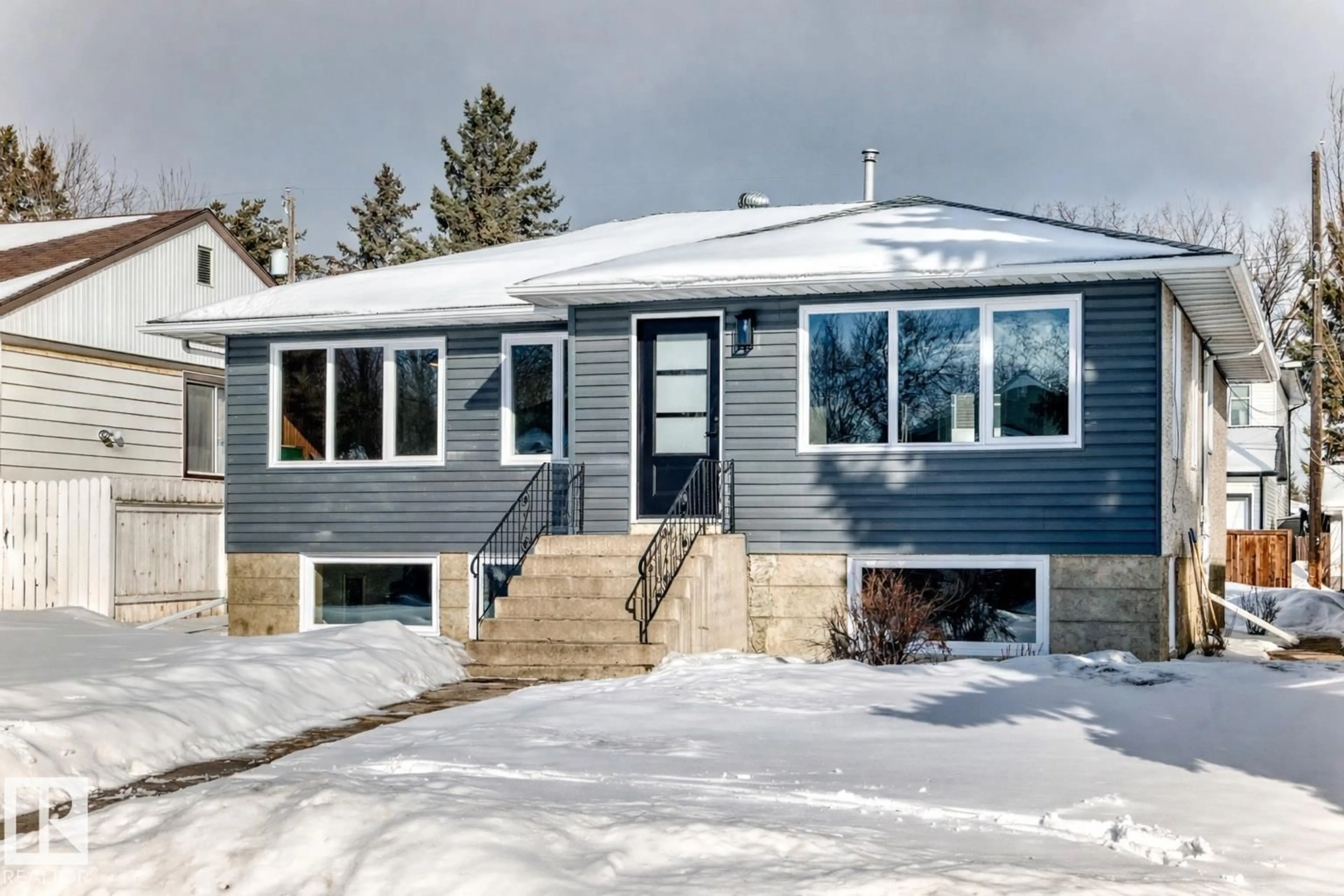 Home with vinyl exterior material, street for NW - 8712 89 AV, Edmonton Alberta T6C1N7