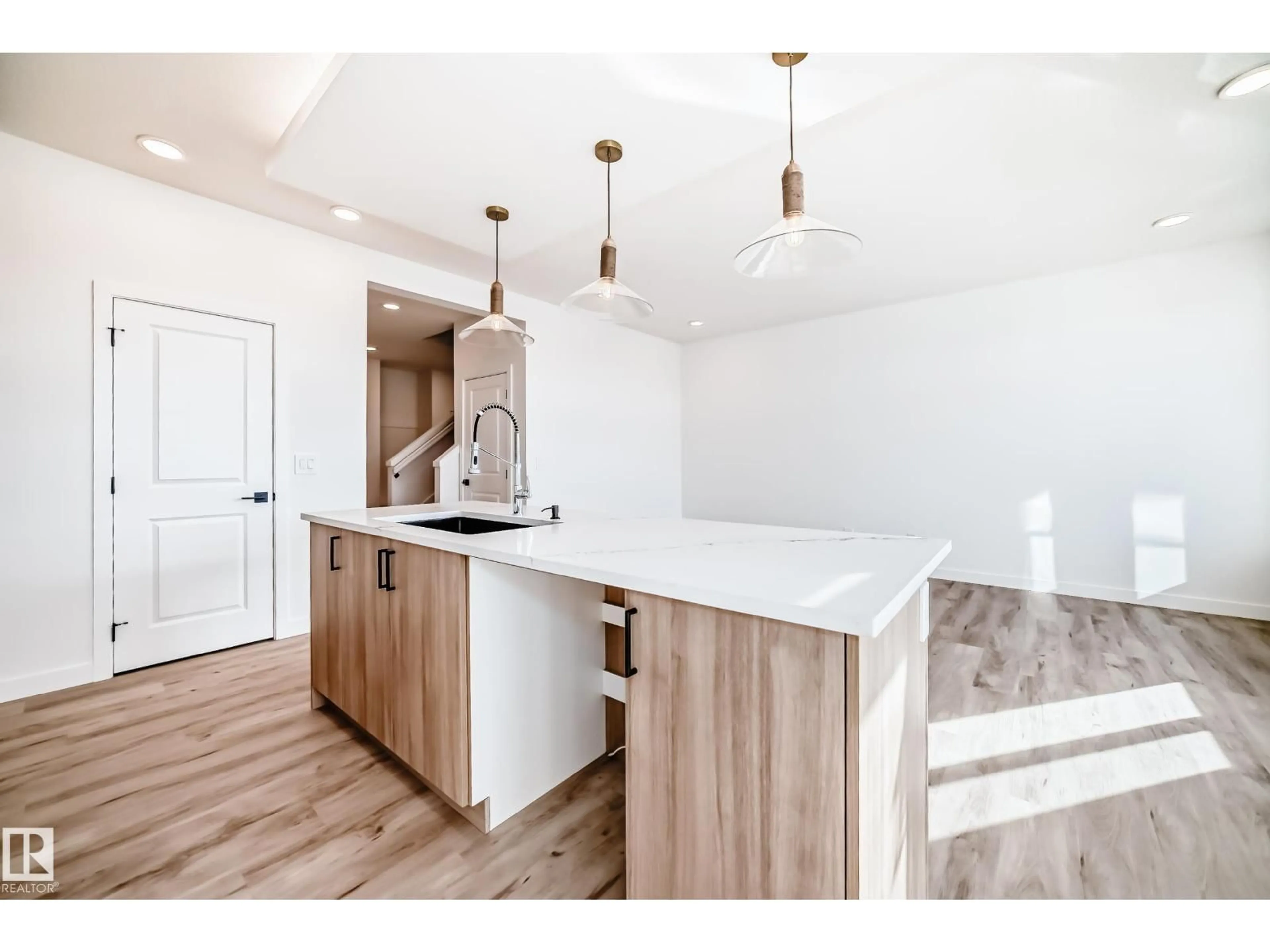 Open concept kitchen, wood/laminate floor for SW - 8229 KIRIAK LO, Edmonton Alberta T6W5S2