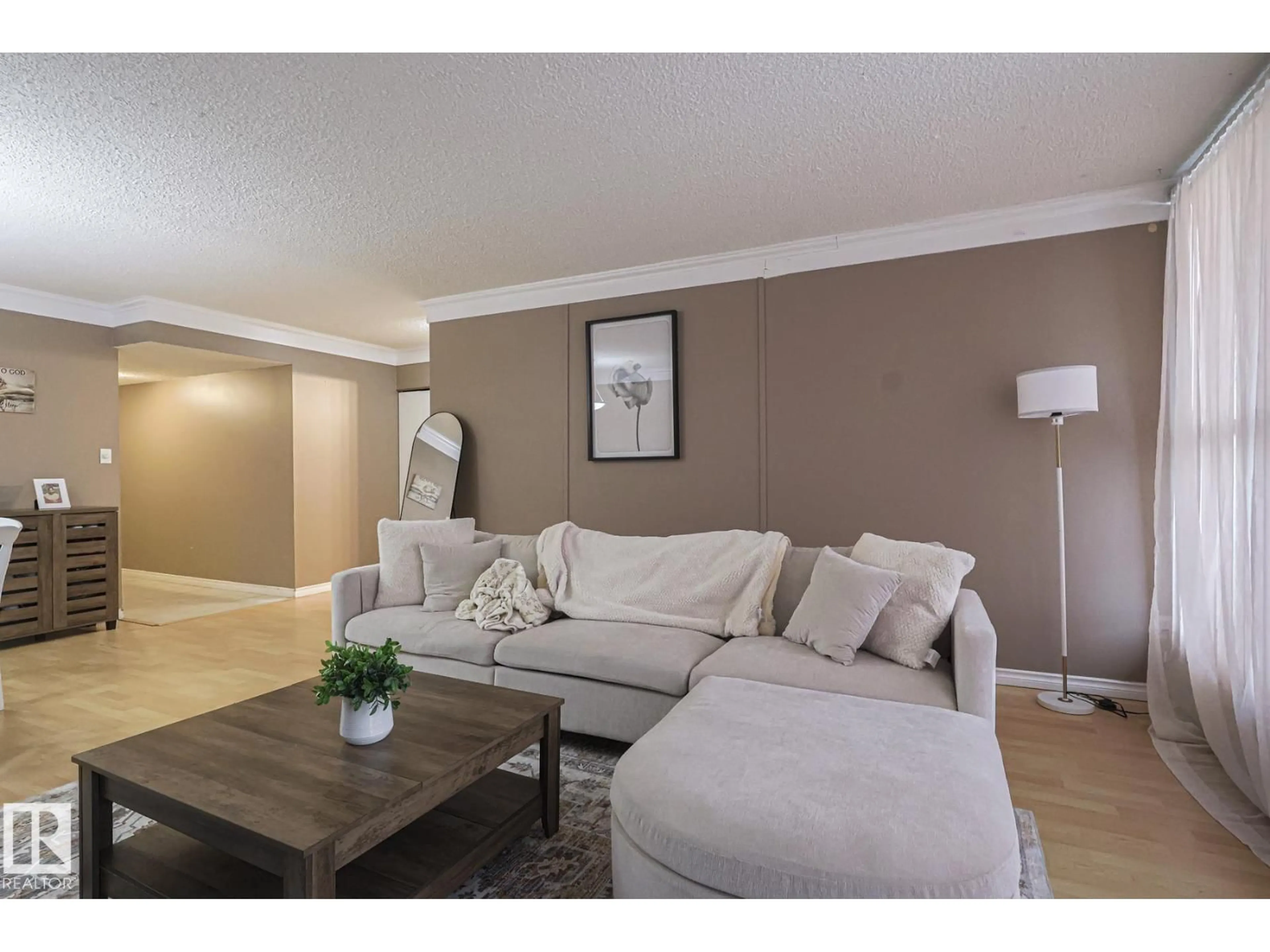 Living room with furniture, wood/laminate floor for 147 8745 165 ST, Edmonton Alberta T5R2R7