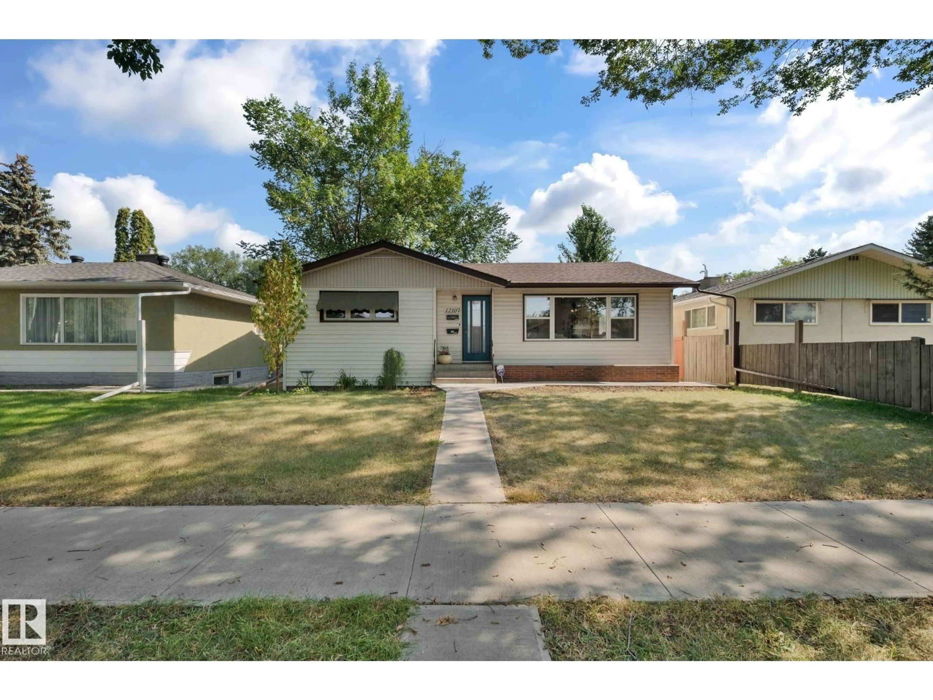 Home with vinyl exterior material, street for 12107 53 ST, Edmonton Alberta T5W3L8
