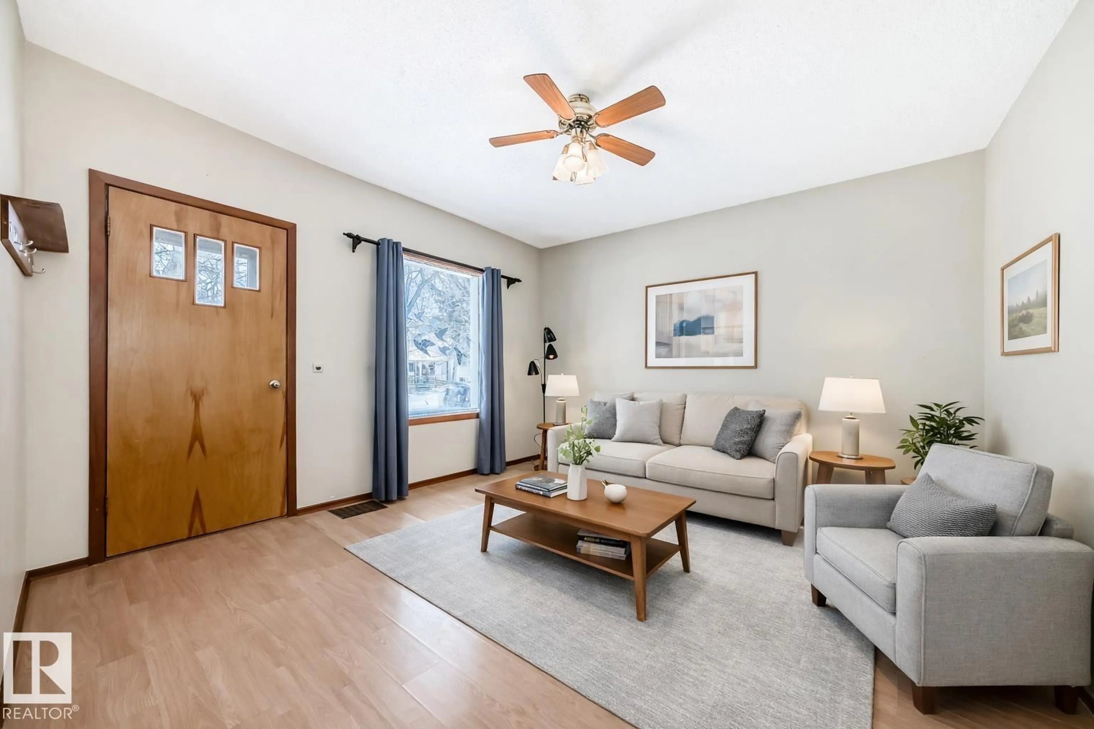 Living room with furniture, wood/laminate floor for 9823 75 AV, Edmonton Alberta T6E1H9