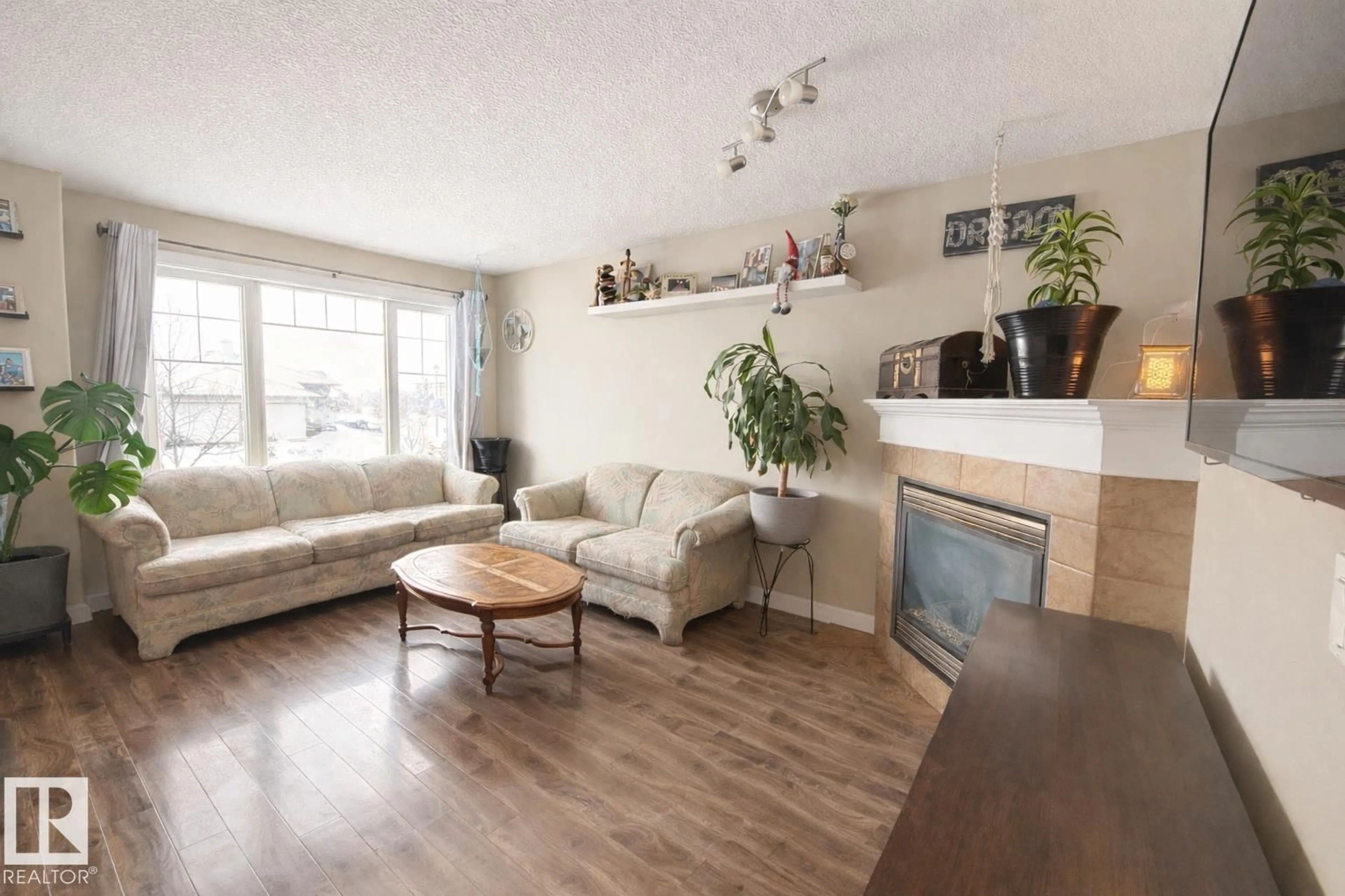 Living room with furniture, wood/laminate floor for 29 WALTERS CO, Leduc Alberta T9E0H9