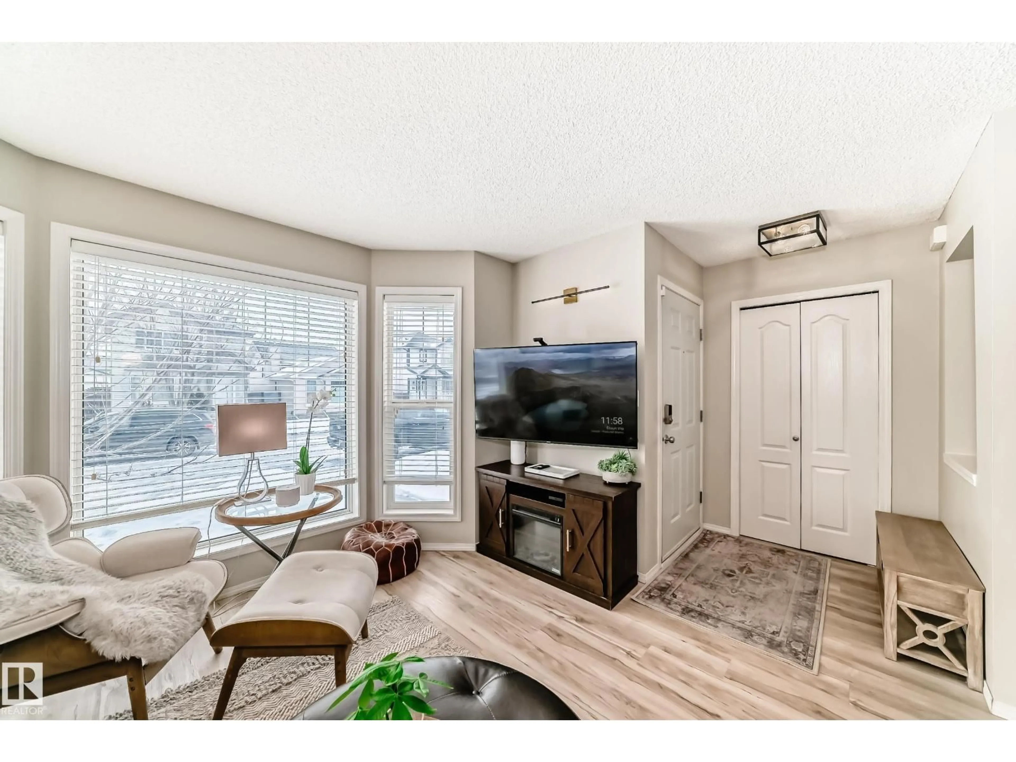 Living room with furniture, wood/laminate floor for 614 88A ST, Edmonton Alberta T6X1C3