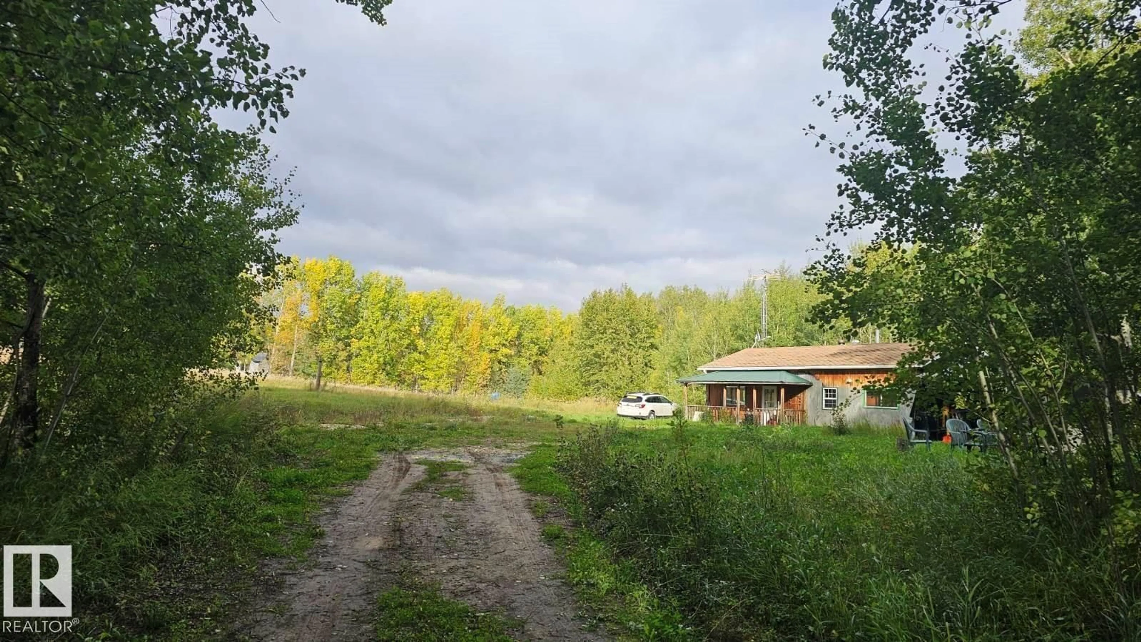 A pic from outside/outdoor area/front of a property/back of a property/a pic from drone, forest/trees view for #6 - 2415 TWP ROAD 521, Rural Parkland County Alberta T0E0H0
