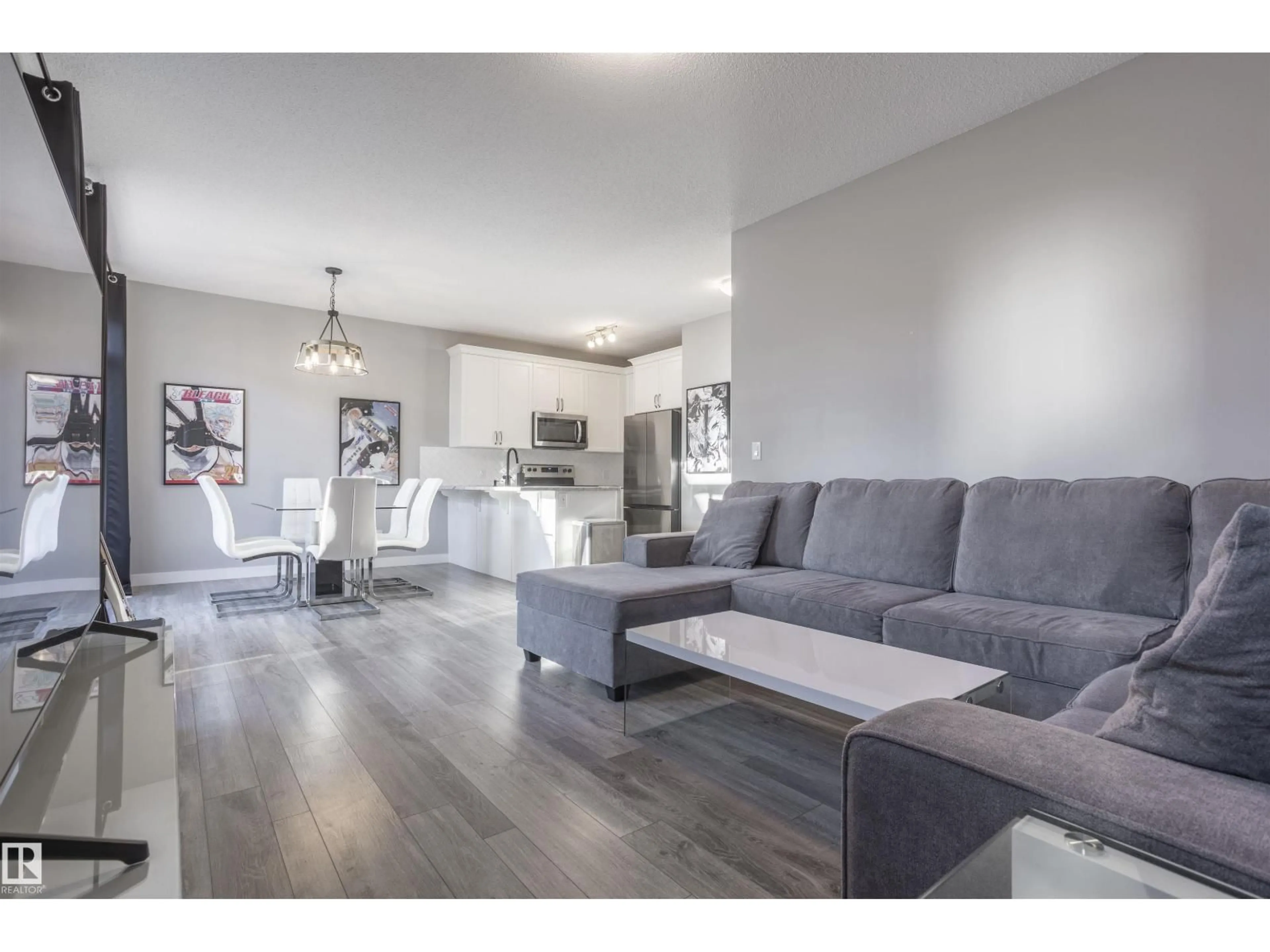 Living room with furniture, wood/laminate floor for 20031 18 AV, Edmonton Alberta T6M0Y1