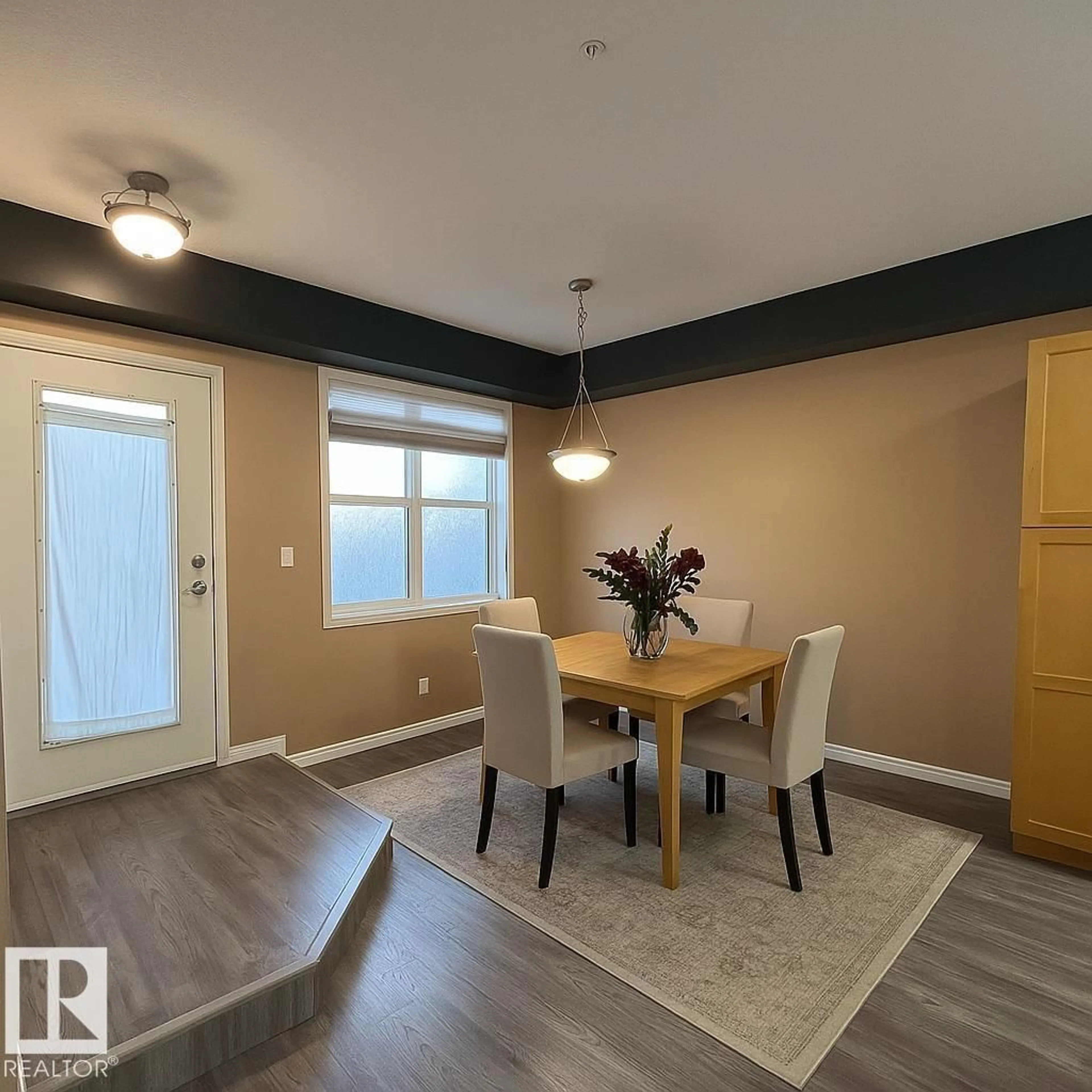 Dining room, wood/laminate floor for #113 - 9507 101 AV NW, Edmonton Alberta T5H4R1