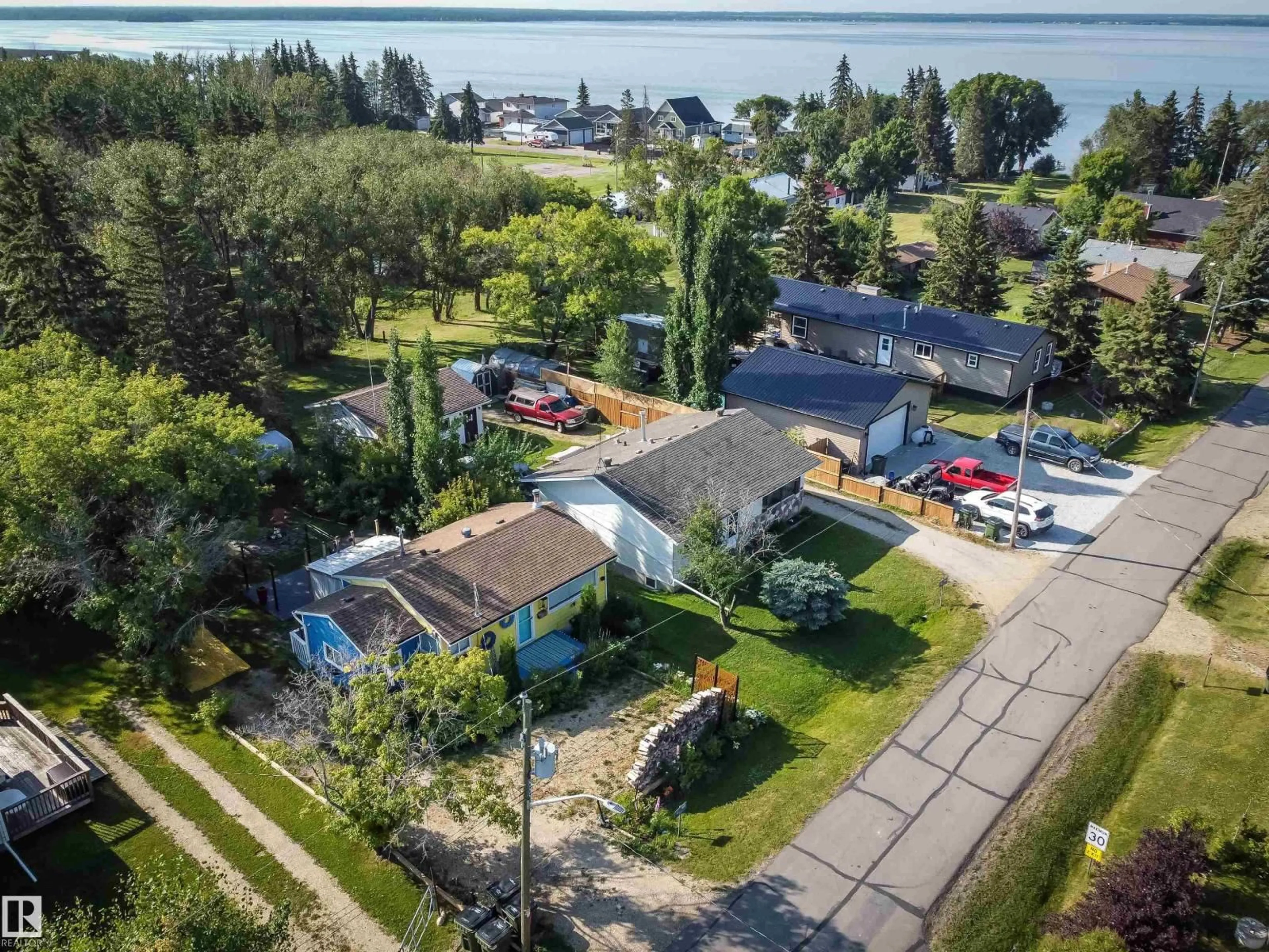 A pic from outside/outdoor area/front of a property/back of a property/a pic from drone, water/lake/river/ocean view for 303 3 ST, Rural Lac Ste. Anne County Alberta T0E1A0